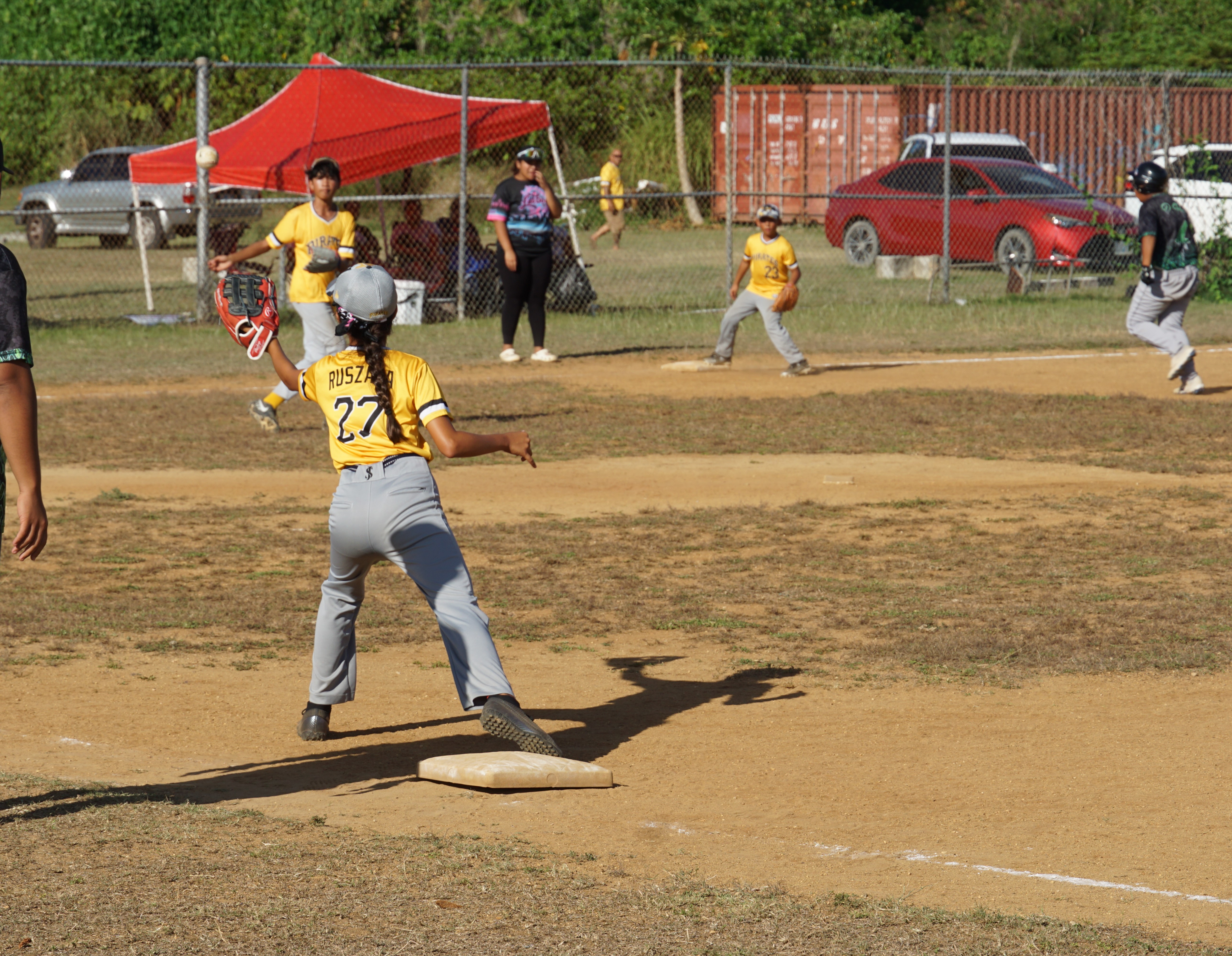The Pirates’ first baseman, Leilani Ruszala, reaches for the pick-off during a game against the Cobras in the majors division of the 2024 NSA Youth Baseball League at the Miguel "Tan Ge" Palacios Baseball Field on Saturday.
