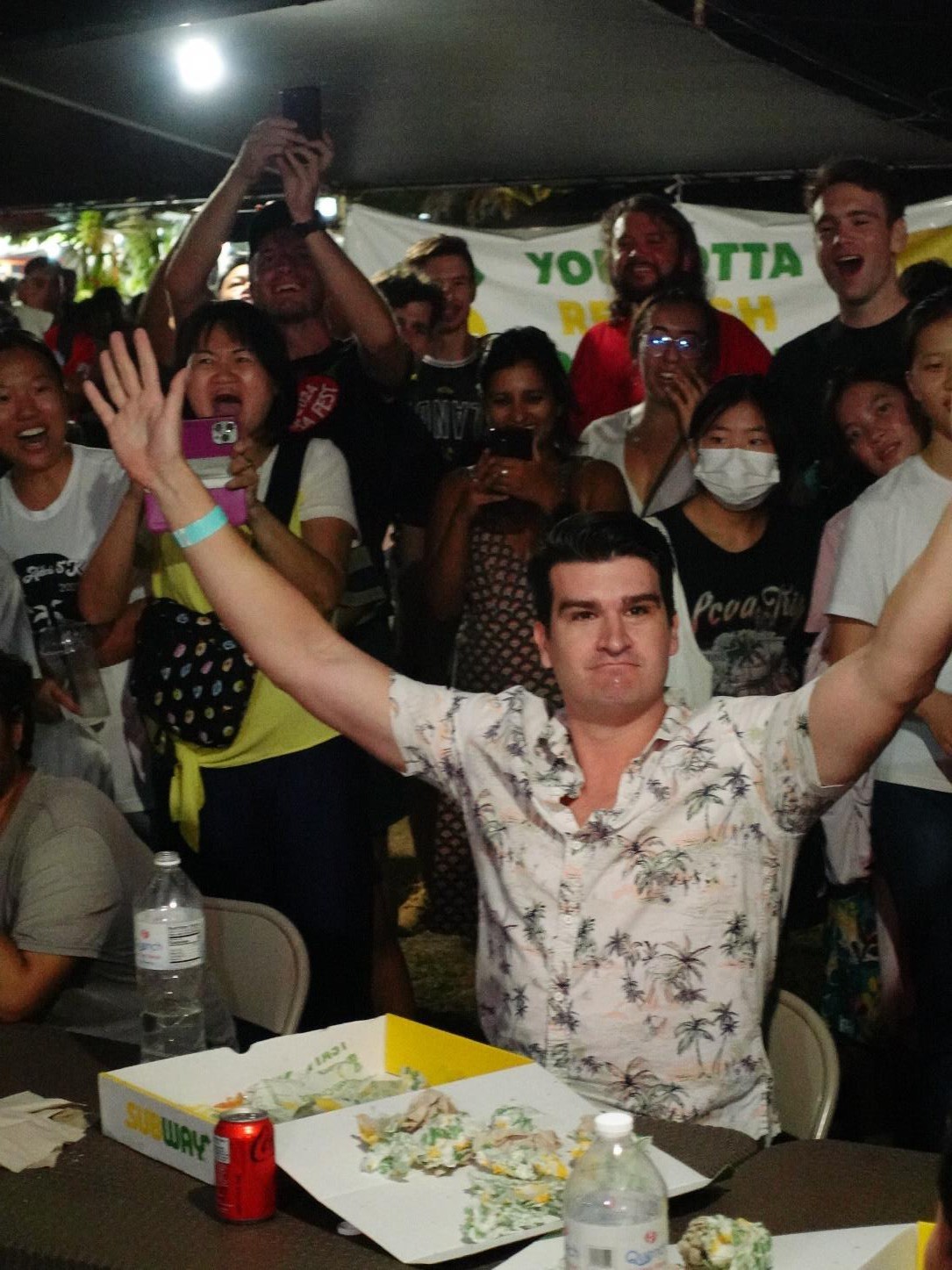 Jeremy Rother comes in right under the clock to finish five footlongs in under one hour during the Subway Sandwich Challenge at the 25th Annual Taste of the Marianas International Food Festival on May 4, 2024 at American Memorial Park.  Rother, along with 2nd place finisher Bob Liu and 3rd place finisher Michael Ma, will move on to the Oh My Grill (OMG) International Food Challenge against competitors from Japan and Korea on May 11 at the festival.
