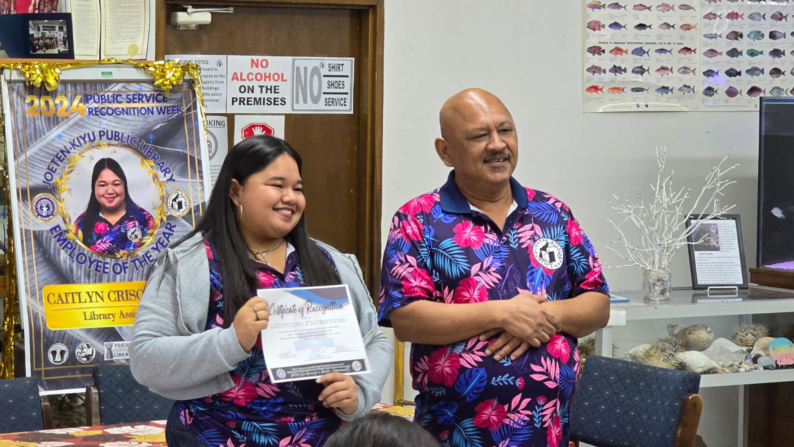 Employee of the Year Caitlyn Crisostomo and Acting Director Vincent Sablan.