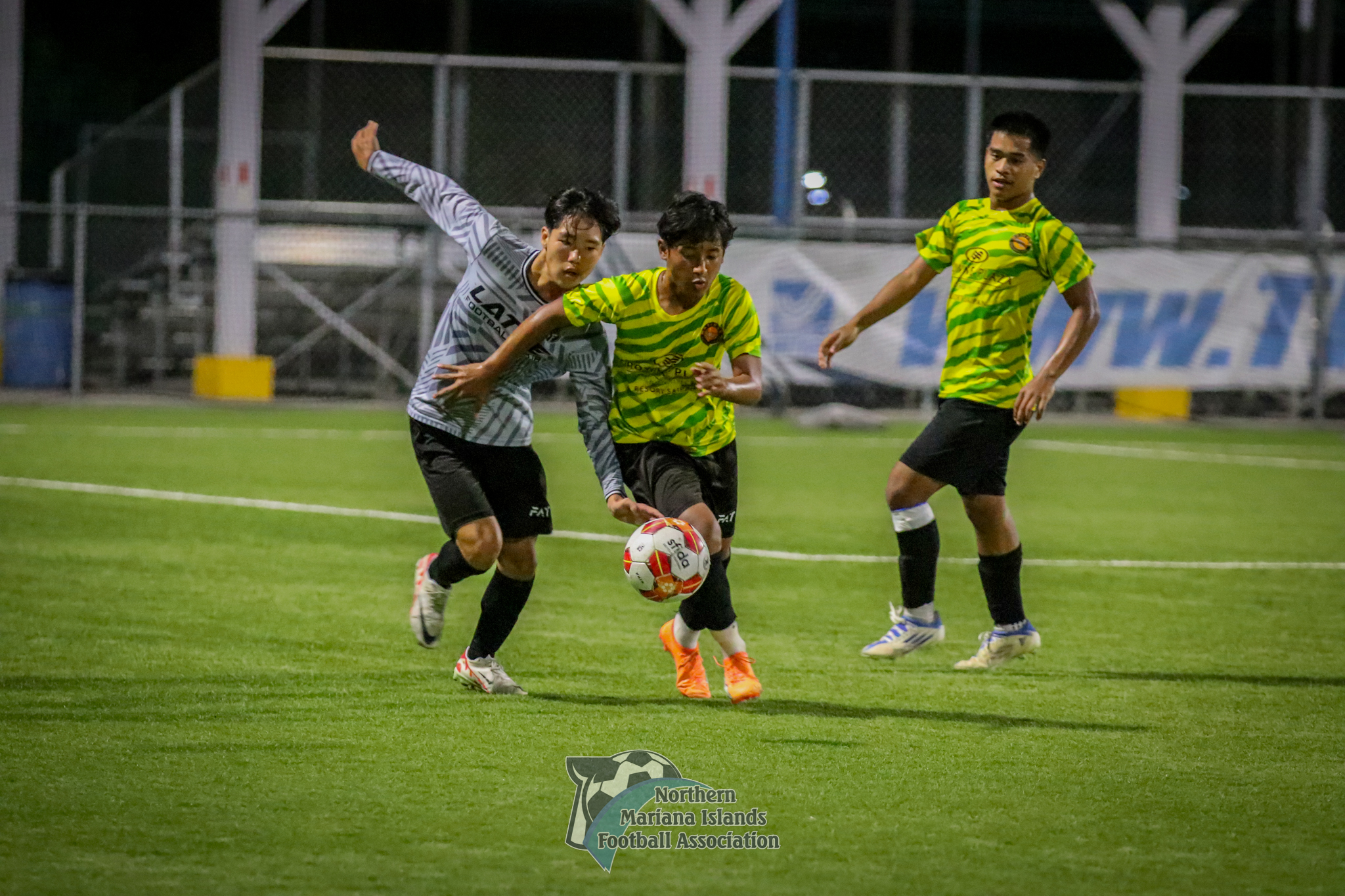 Latte FC's Chanwoong Yeom and a Matansa FC player battle for the possession during a U17 boys division semifinal match of the TakeCare Youth Soccer League Spring 2024 at the NMI Soccer Training Center in Koblerville on Saturday.