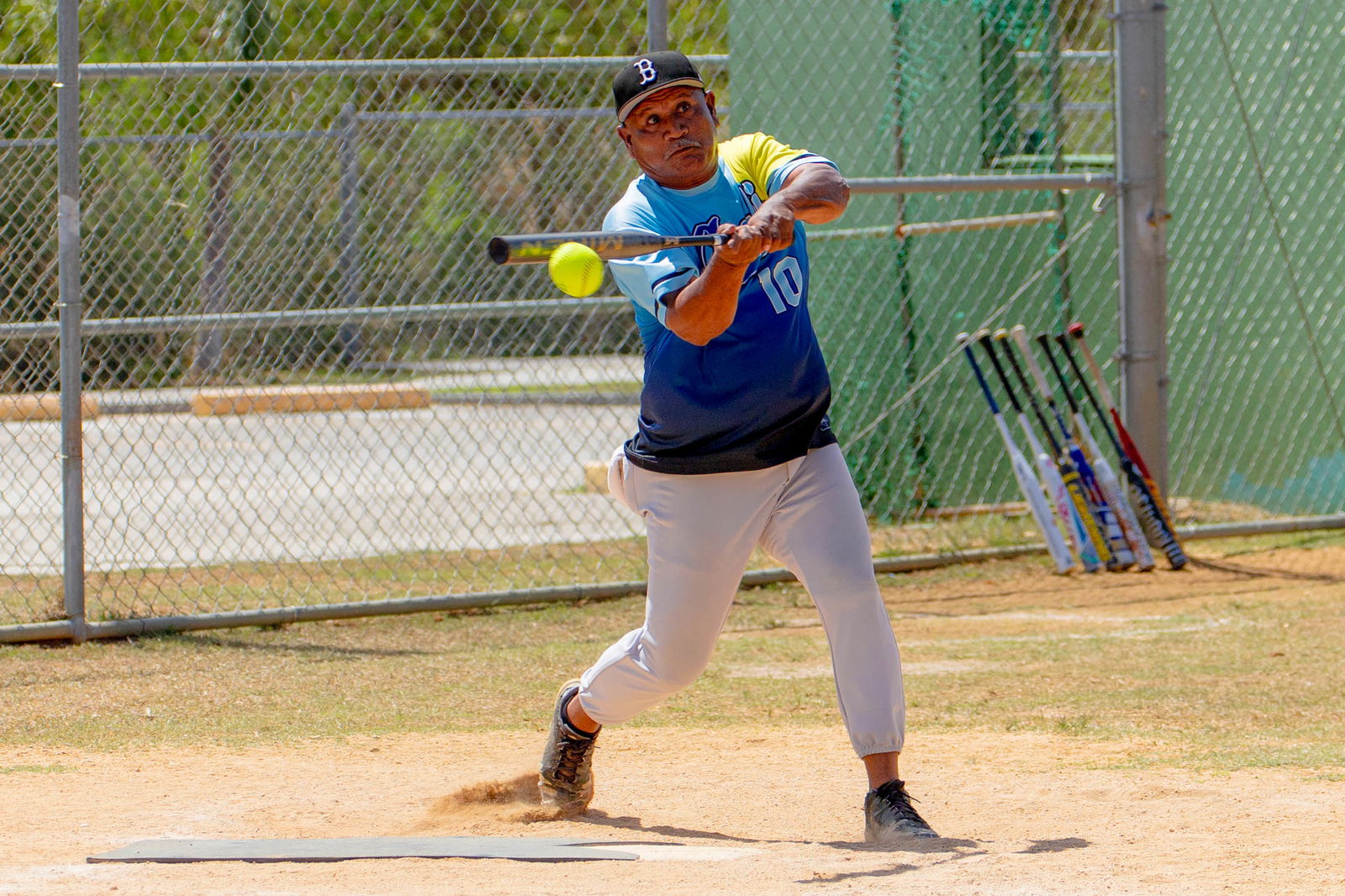 Asahi's Darwin Masaharu connects a single during a 2024 Budweiser Belau Amateur Softball Association League game at the Dandan baseball field on Sunday.