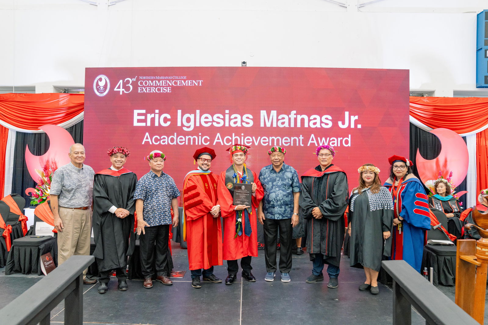 Eric Iglecias Mafnas Jr., who graduated summa cum laude with an Associate of Applied Science in Criminal Justice, was honored with the Academic Excellence Award at Northern Marianas College’s 43rd Commencement Exercise on May 17, 2024, at the Marianas High School Gymnasium. Pictured with Mafnas, from left, are keynote speaker U.S. Congressman Gregorio Kilili Camacho Sablan, NMC Vice President for Administration and Advancement Frankie Eliptico, CNMI Gov. Arnold I. Palacios, NMC President Galvin Deleon Guerrero, EdD, CNMI Lt. Gov. David M. Apatang, NMC Board of Regents Chair Charles Cepeda, NMC Dean of Student Support Services Charlotte Cepeda, and NMC Acting Dean of Academic Programs and Services Dr. Barbara Hunter.
