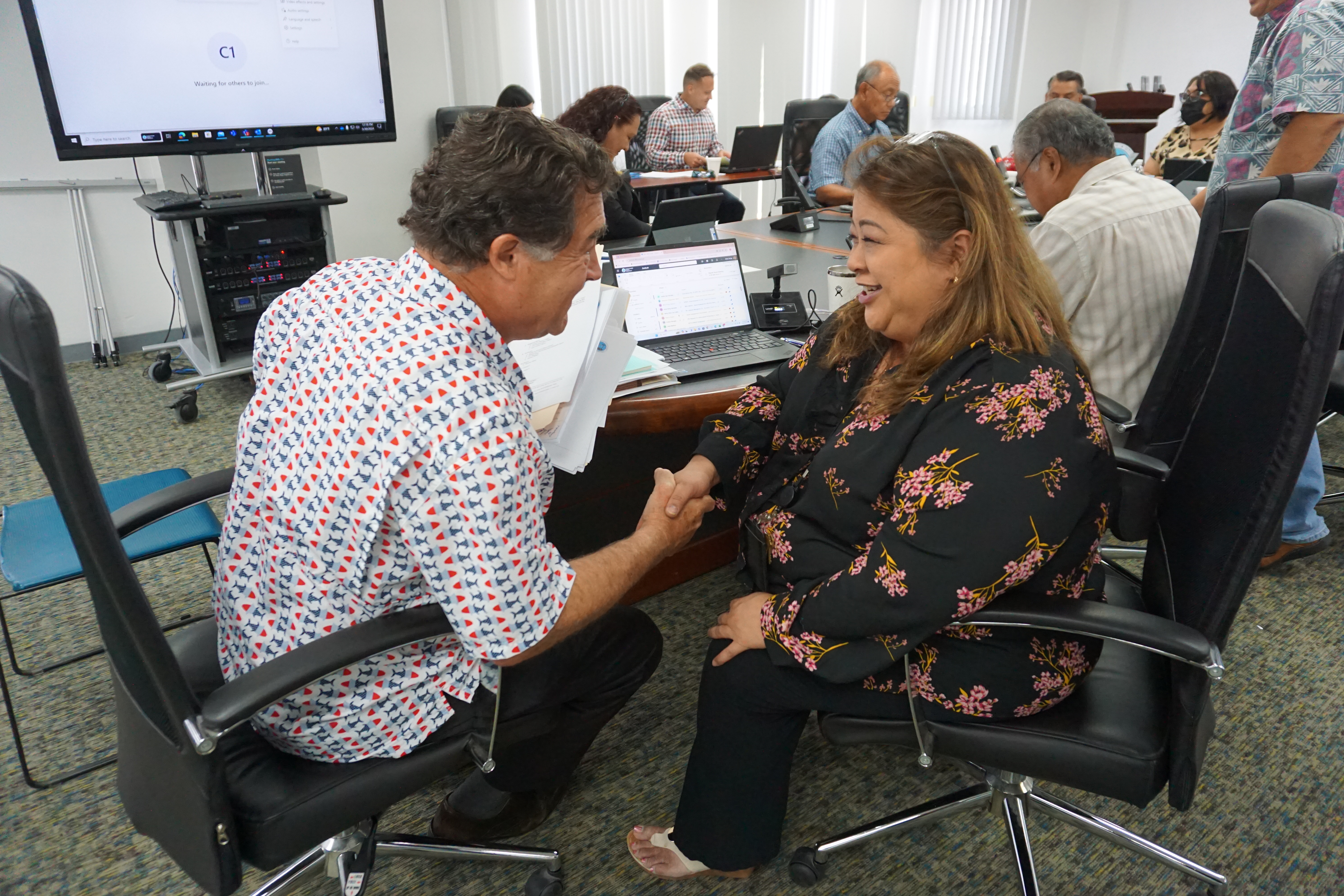 Acting Commonwealth Utilities Corp. Executive Director Betty Terlaje, right, shakes hands with Kevin Watson after the CUC board of directors unanimously offered him the executive director’s job on Thursday.