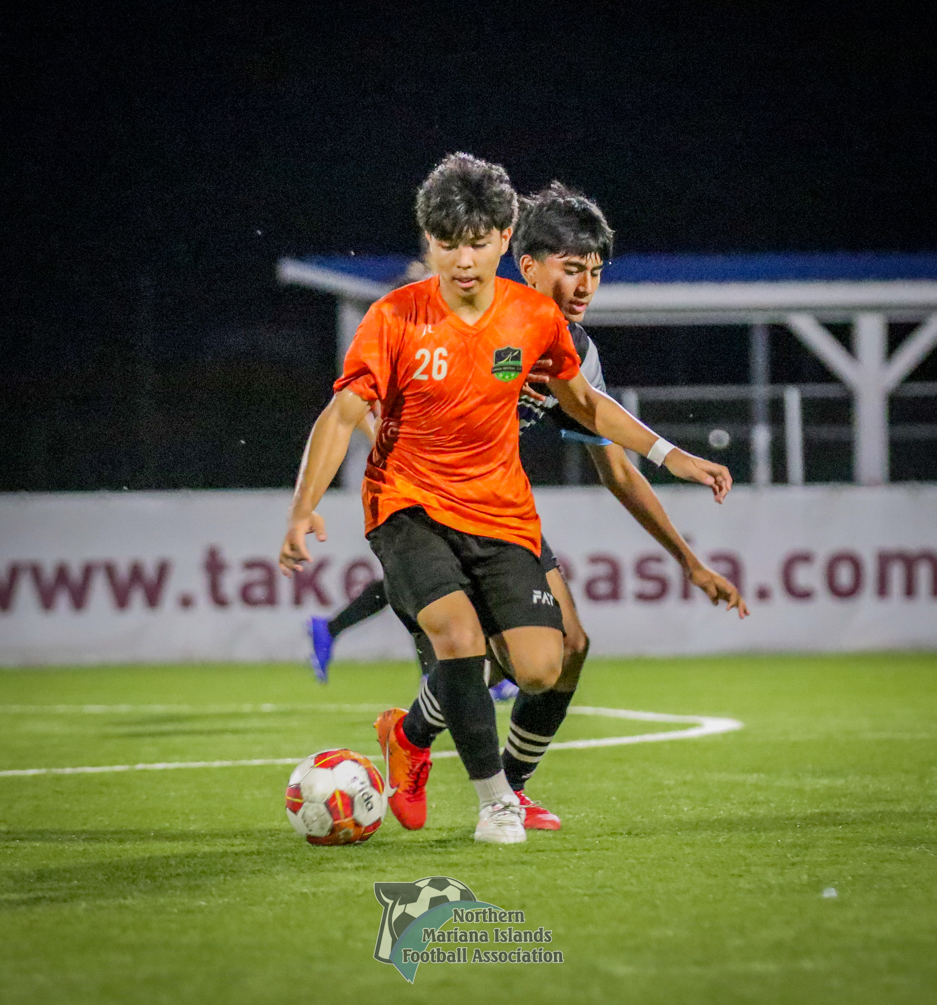 Kanoa FC's Paul Lizama sets up the play as he protects the possession from an MPU defender during a U17 boys division semifinal match of the TakeCare Youth Soccer League Spring 2024  at the NMI Soccer Training Center in Koblerville on Saturday.