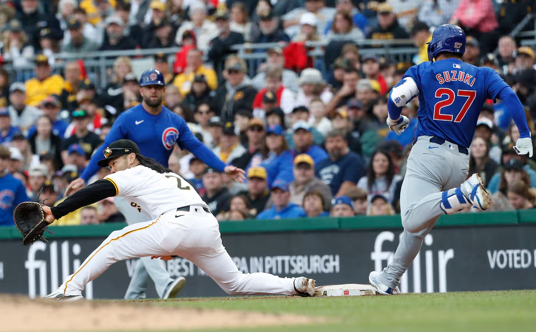 Chicago Cubs right fielder Seiya Suzuki (27) beats the throw to Pittsburgh Pirates first baseman Connor Joe (2) for an infield single during the fifth inning at PNC Park in Pittsburgh, Pennsylvania, May 11, 2024.