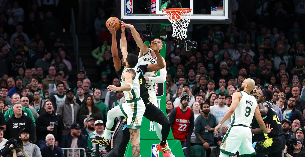 Boston Celtics forward Jayson Tatum (0) and Boston Celtics center Kristaps Porzingis (8) block Indiana Pacers center Myles Turner (33) during the second half at TD Garde in Boston, Massachusetts, Jan. 30, 2024.