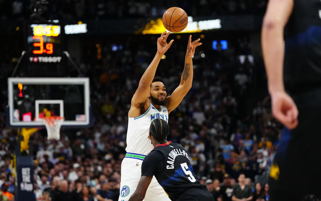 Minnesota Timberwolves center Karl-Anthony Towns (32) passes the ball over Denver Nuggets guard Kentavious Caldwell-Pope (5) in the first quarter in game seven of the second round for the 2024 NBA playoffs at Ball Arena in Denver, Colorado, May 19, 2024.