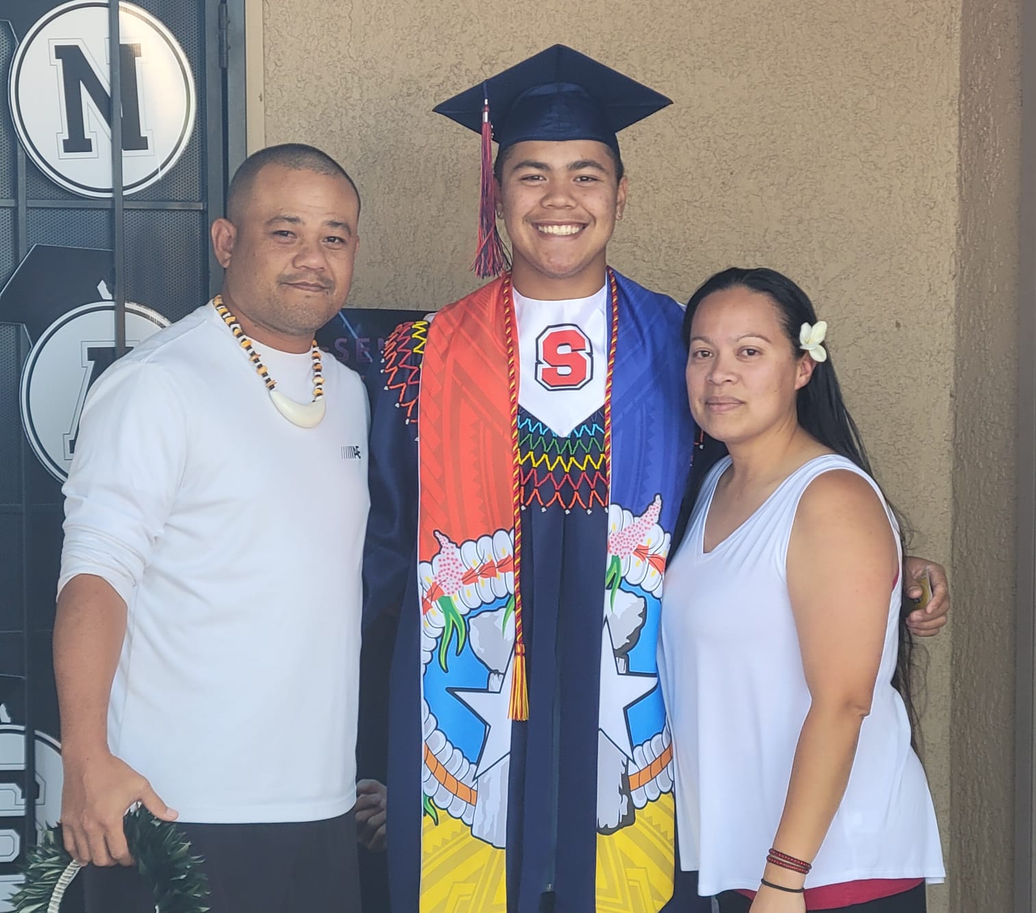Francisco Aldan-Sablan poses with parents, Joaquin C. Taitano and Manuela A. Sablan, after graduating from Sahuaro High School in Arizona on May 23, 2024.