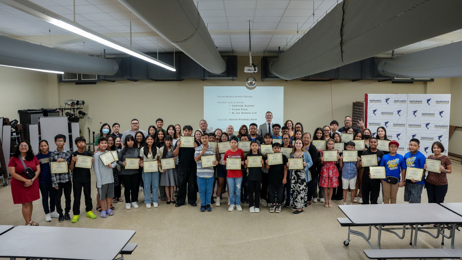 The Public School System students and teachers who have earned the Achieve3000 literacy gains distinction pose for a photo with Board of Education Secretary/Treasurer Gregory Pat Borja, Commissioner of Education Dr. Lawrence F. Camacho and other education officials.
