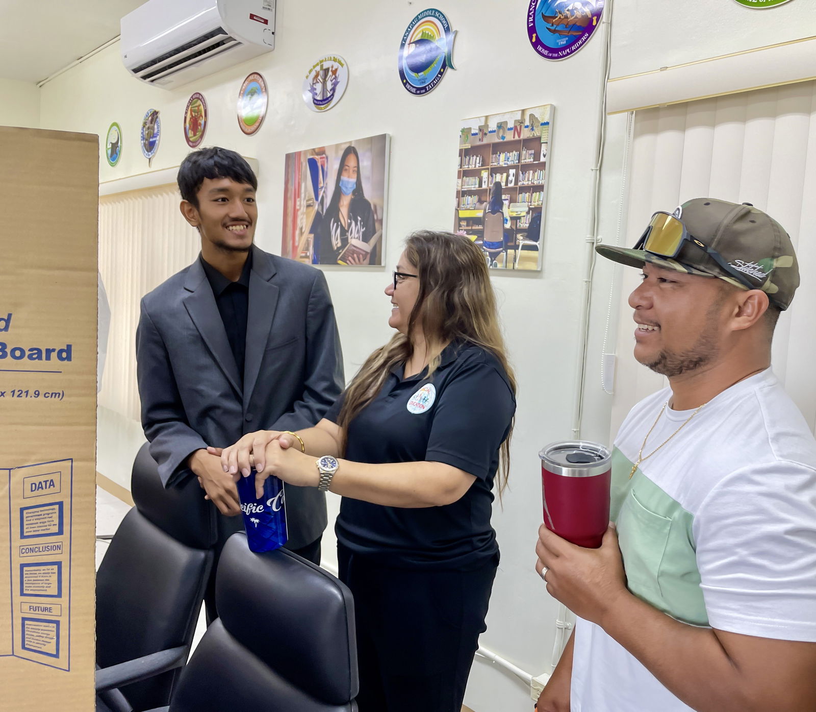Special Education State Director Donna M. Flores, center, and Kagman High School Principal Ben Jones with SSHS AP student Simon Tang.