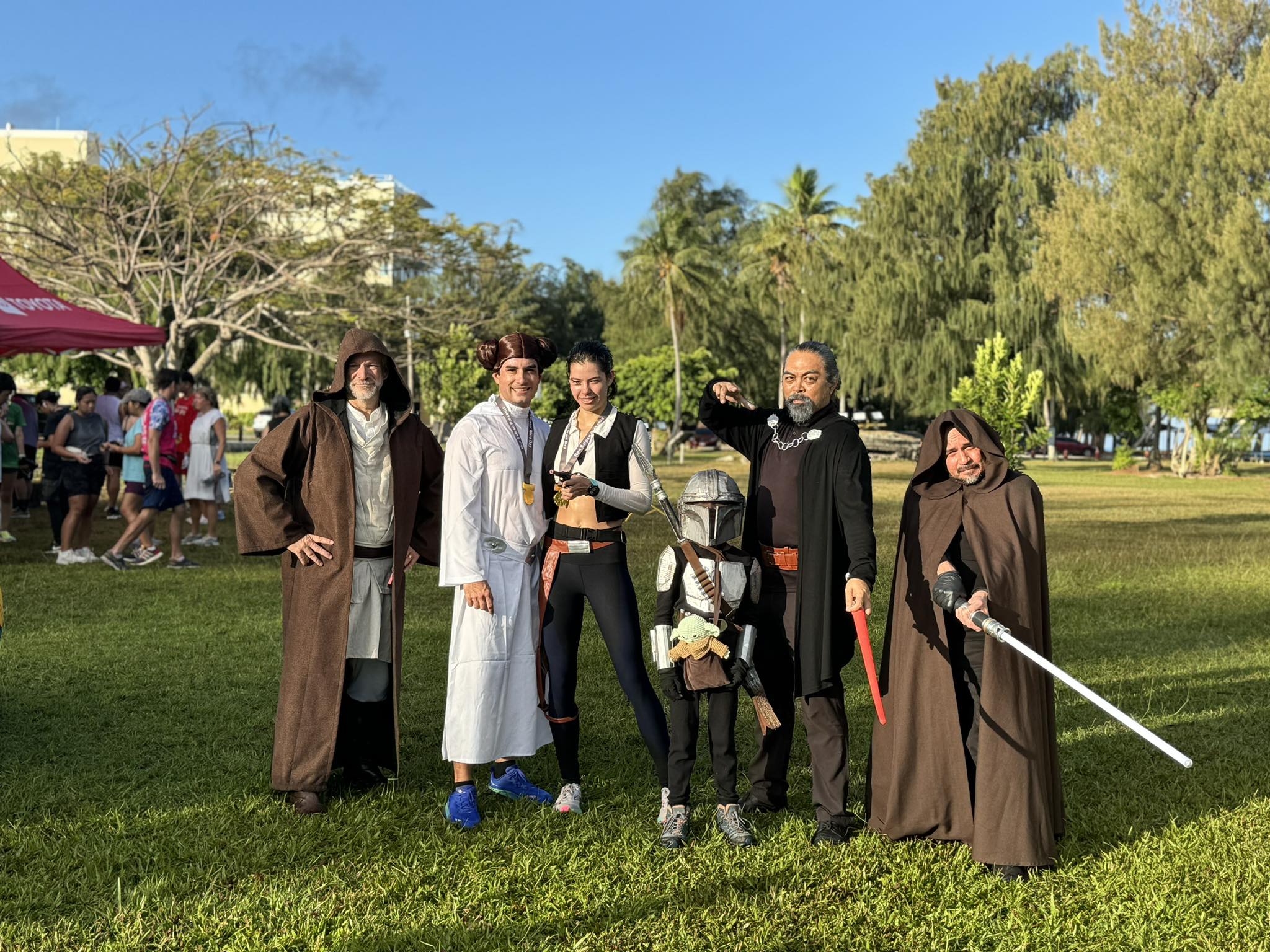 The winners of the costume contest pose for a photo with avid runners and Star Wars fans Dr. Ronald Snyder, left, Saipan International School headmaster, and Dr. Galvin S. Deleon Guerrero, Northern Marianas College president, right.