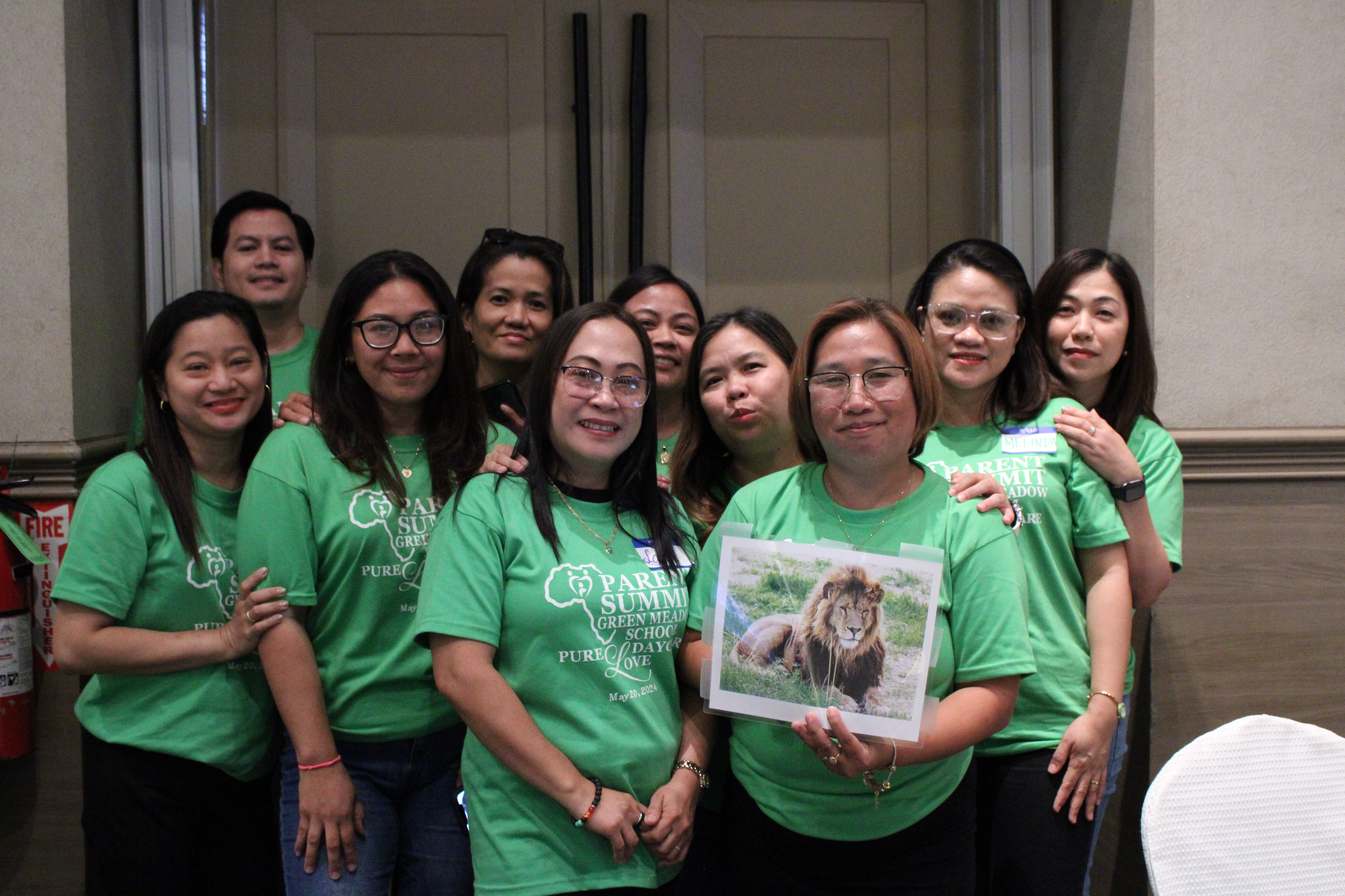 Parents pose for a photo after completing an “ice breaker” activity.