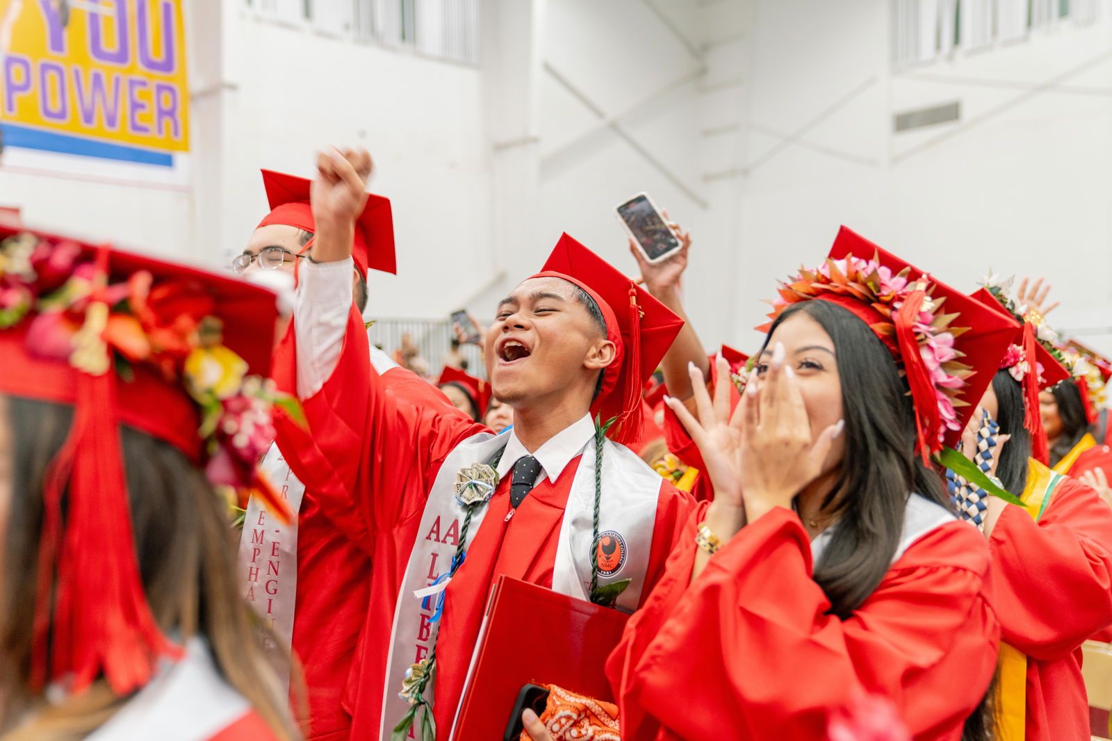 Northern Marianas College graduates cheer as they receive their degrees Friday at the MHS gym.