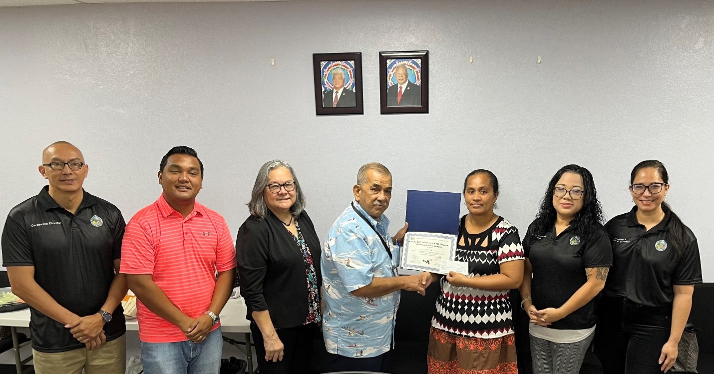 Family Self-Sufficiency graduate Peggy Hong with Northern Marianas Housing Corporation board members, corporate director, deputy corporate director and program and housing specialist.