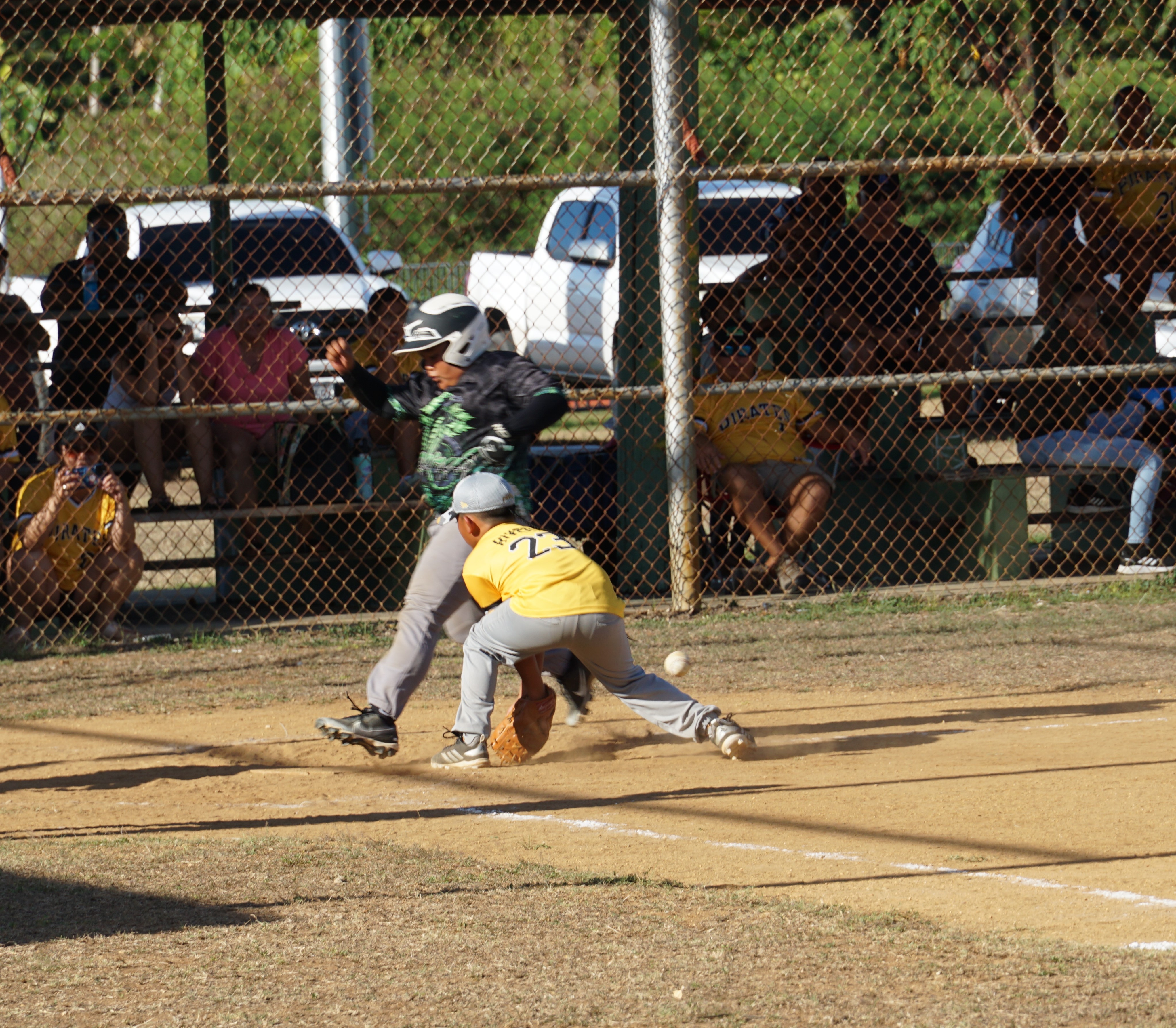 A runner from the Cobras beats the tag for an earned run during a game in the majors division of the 2024 NSA Youth Baseball League at the Miguel "Tan Ge" Palacios Baseball Field on Saturday.