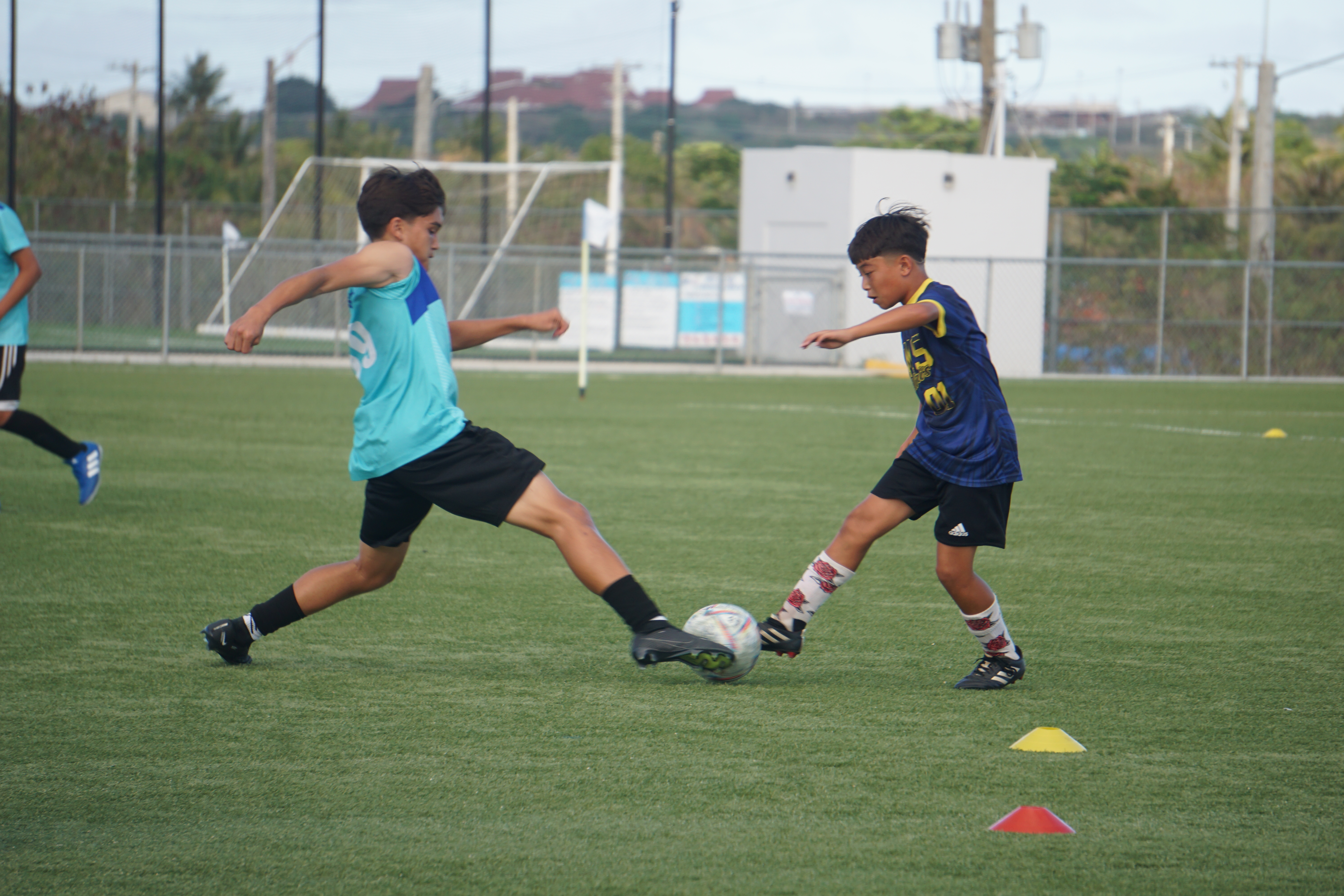 Saipan International School's Landon Springer and Hopwood 1's Joshua Lizama reach out to secure the possession in the boys middle school division title match of the NMIFA-PSS Interscholastic Soccer League SY23-24 at the NMI Soccer Training Center in Koblerville on Thursday.