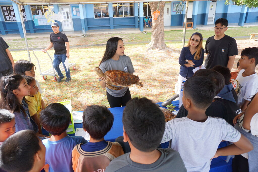 Christina Shaunte P. Tudela of CNMI Sea Turtle Conservation Program discusses sea turtles with Garapan Elementary School students.