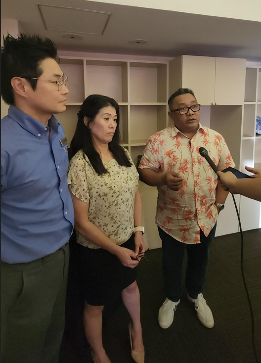 Hotel Association of the NMI Chair Dennis Seo, left, and board member Sachiko Gerrard, center, listen as Vice Chair Ivan Quichocho talks to reporters at Grandvrio where HANMI held its general membership meeting on Thursday, May 23.
