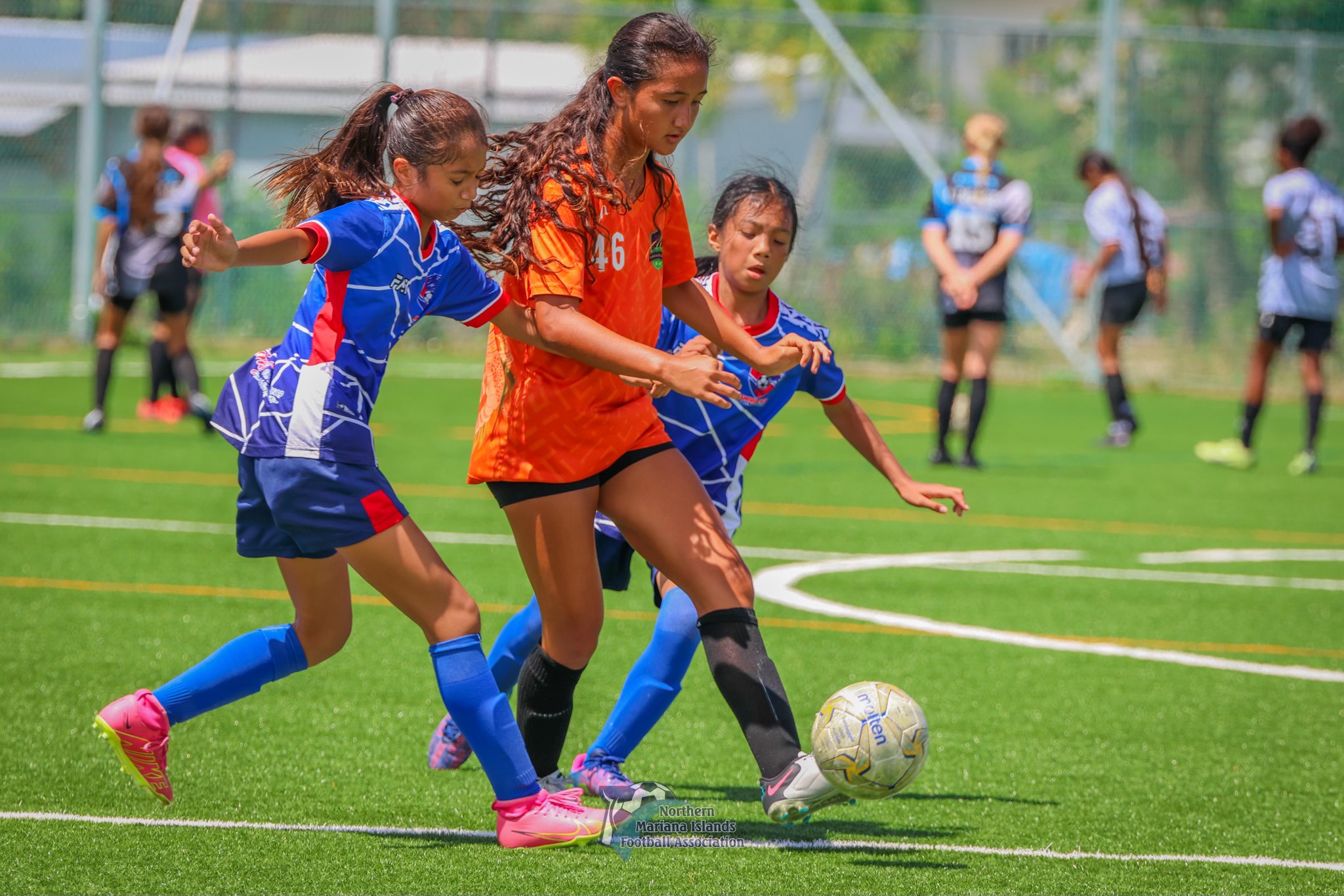 Kanoa FC's Beatrice Gross dribbles past two Shirley's FC defenders during the U14 girls championship game of the TakeCare Youth Soccer League Spring 2024 at the NMI Soccer Training Center in Koblerville on Saturday.