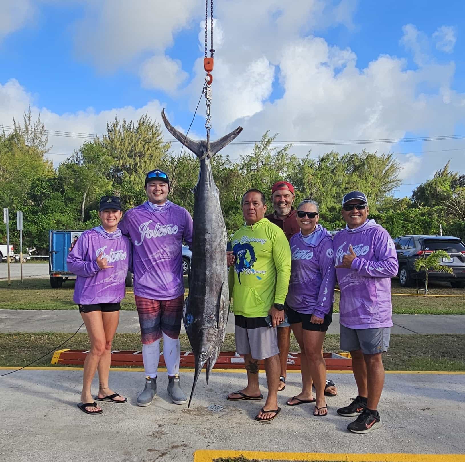 The crewmembers of Jolene, who include Luther Taylor, second right, and boat captain Alex Sablan, right, pose with their 101-pound marlin, which won the inaugural Tasi To Table’s CNMI “Reel Heroes” International Fishing Derby at the Smiling Cove Marina on Saturday.