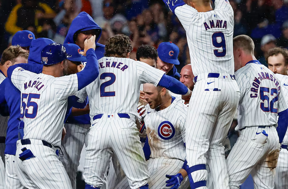 Chicago Cubs first baseman Michael Busch (29) celebrates with teammates after hitting a walk-off home run against the San Diego Padres during the ninth inning at Wrigley Field in Chicago, Illinois, May 7, 2024.