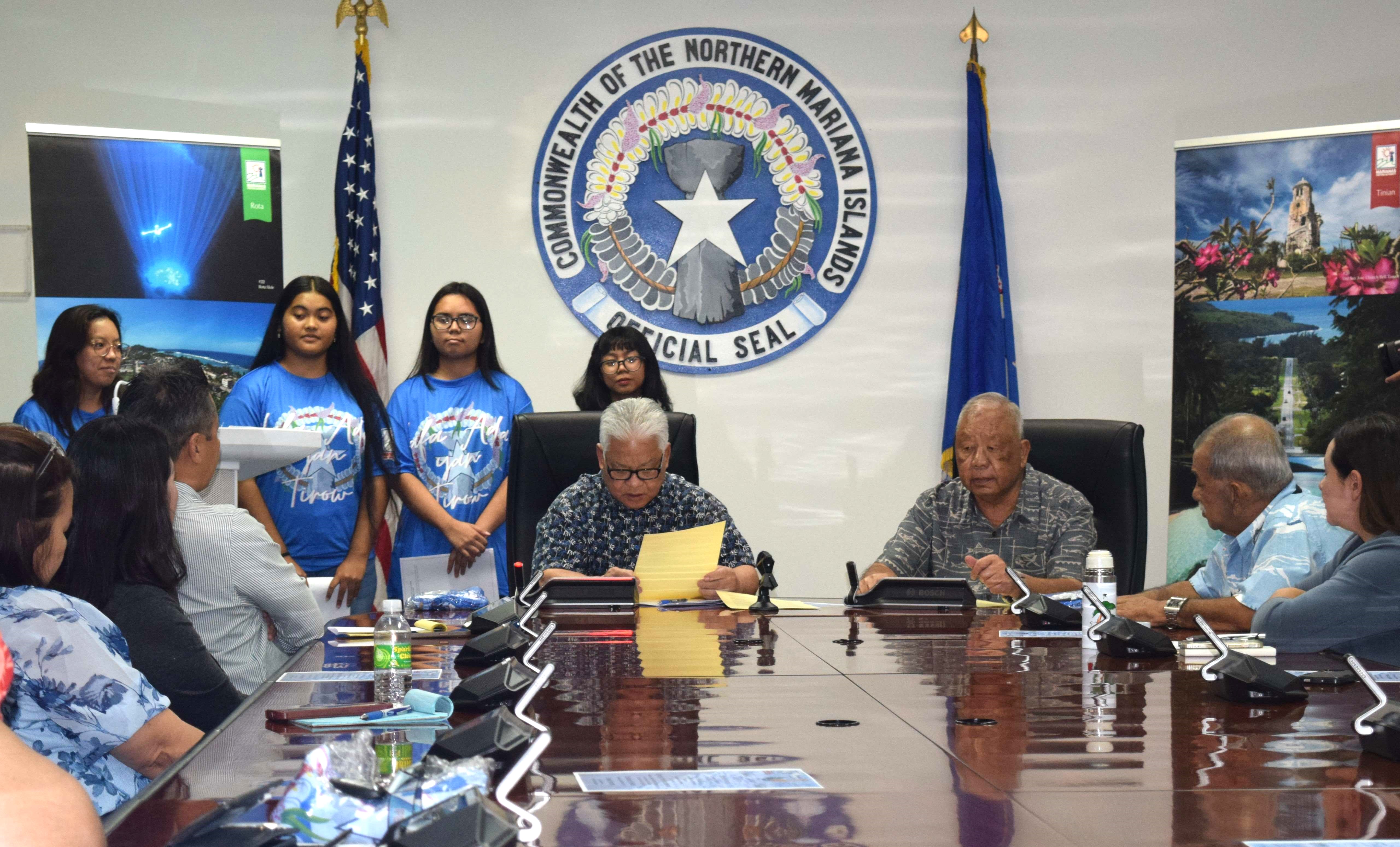 Gov. Arnold I. Palacios signs a proclamation declaring May as  Marianas Tourism Month while Lt. Gov. David M. Apatang looks on in the governor's conference room on Capital Hill on Tuesday.