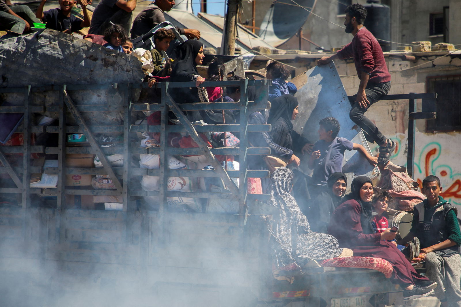 Palestinians travel in a truck as they flee Rafah after Israeli forces launched a ground and air operation in the eastern part of the southern Gaza city, amid the ongoing conflict between Israel and Hamas, in Rafah, in the southern Gaza Strip, May 8, 2024.