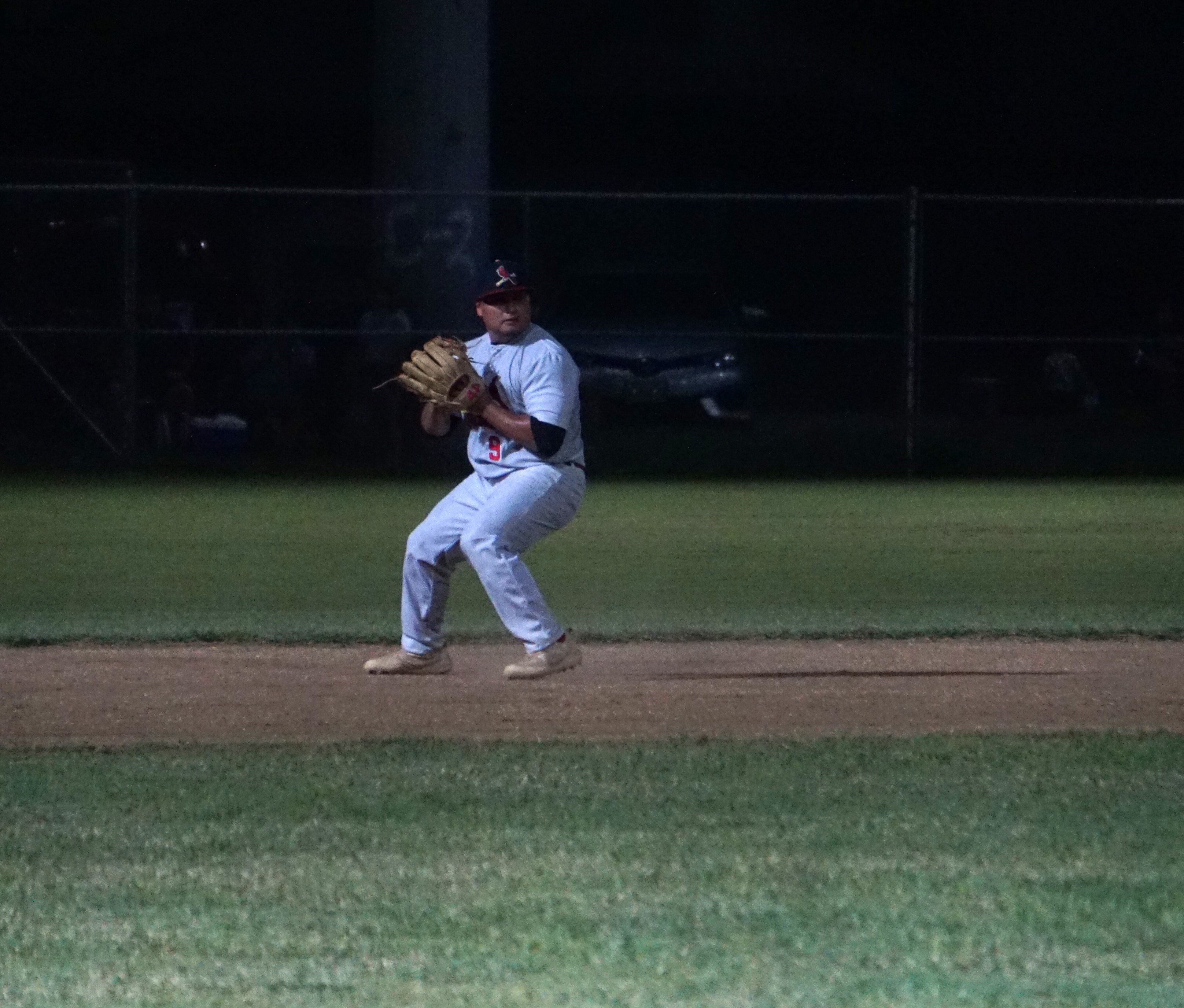 Cardinals shortstop Nokki Saralu secures a grounder and gathers to throw to first base for the out during a Tan Holdings Saipan Baseball League game at the Francisco "Tan Ko" Palacios Baseball Field.
