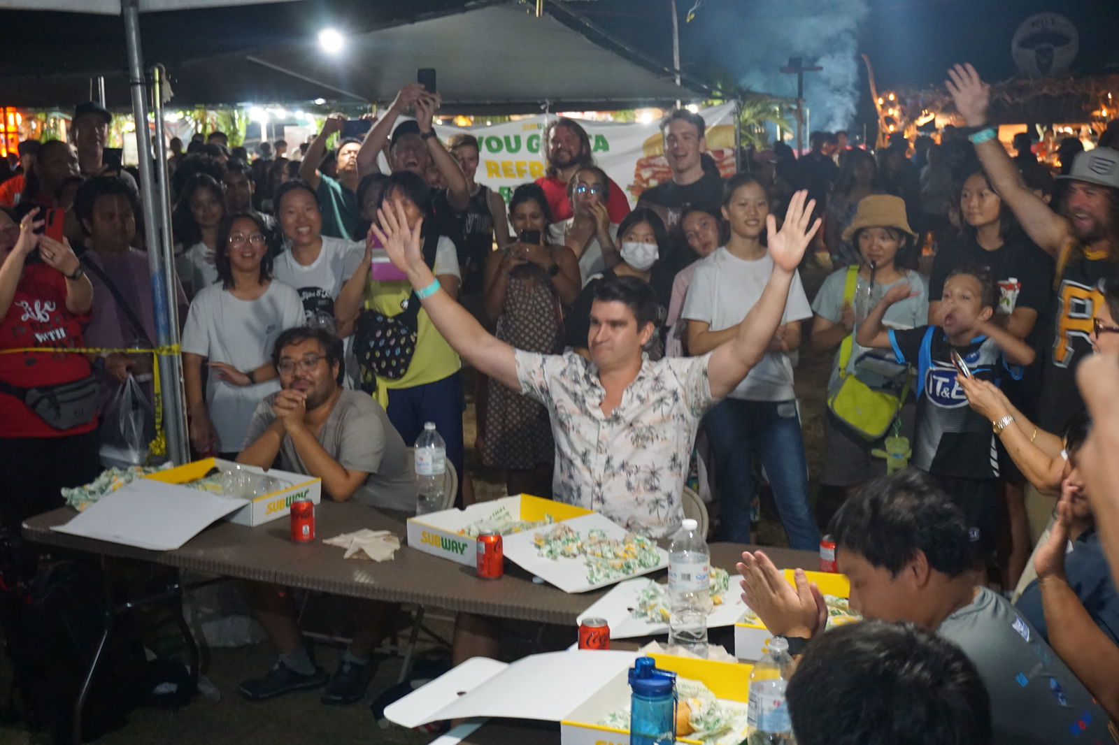 Jeremy Rother, a last-minute entry to the Subway Sandwich Challenge, raises his arms in triumph after eating 15 sandwiches.