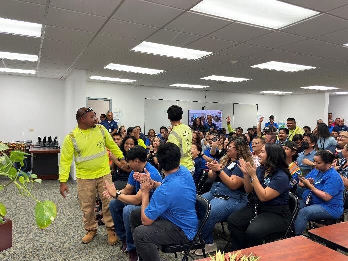 Employees stood proudly as their department was recognized for its good work by the Board Chair.