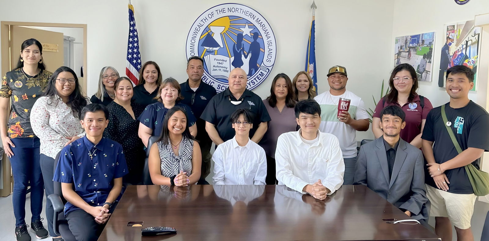 Following their presentation, Saipan Southern High School AP students Christopher Mauricio, Aleeza Castro, Tao Jin, Justin Afable, Simon Tang, all seated, front row, and Jared Borja (not in photo) pose for a photo with Public School System officials led by Commissioner of Education Dr. Lawrence F. Camacho, standing, center. Joining the students in the presentation were their advisers Dr. Dora Miura and Kadmiel Rey, and SSHS Principal Vince Dela Cruz.