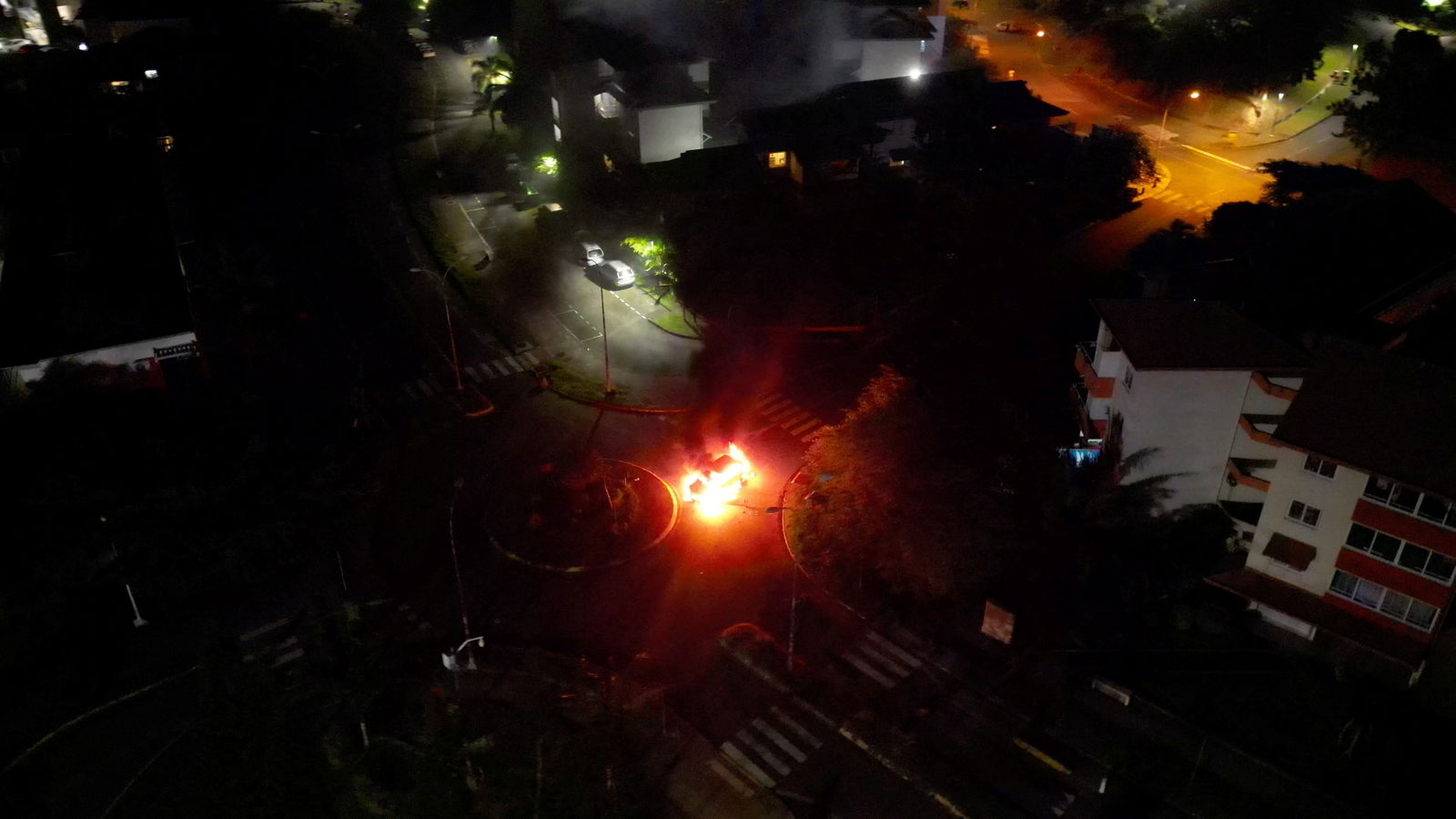 A car is seen lit on fire, amid protests against plans to allow more people to take part in local elections in the French-ruled territory, which indigenous Kanak protesters reject, in Noumea, New Caledonia, May 18, 2024 in this screengrab from video.
