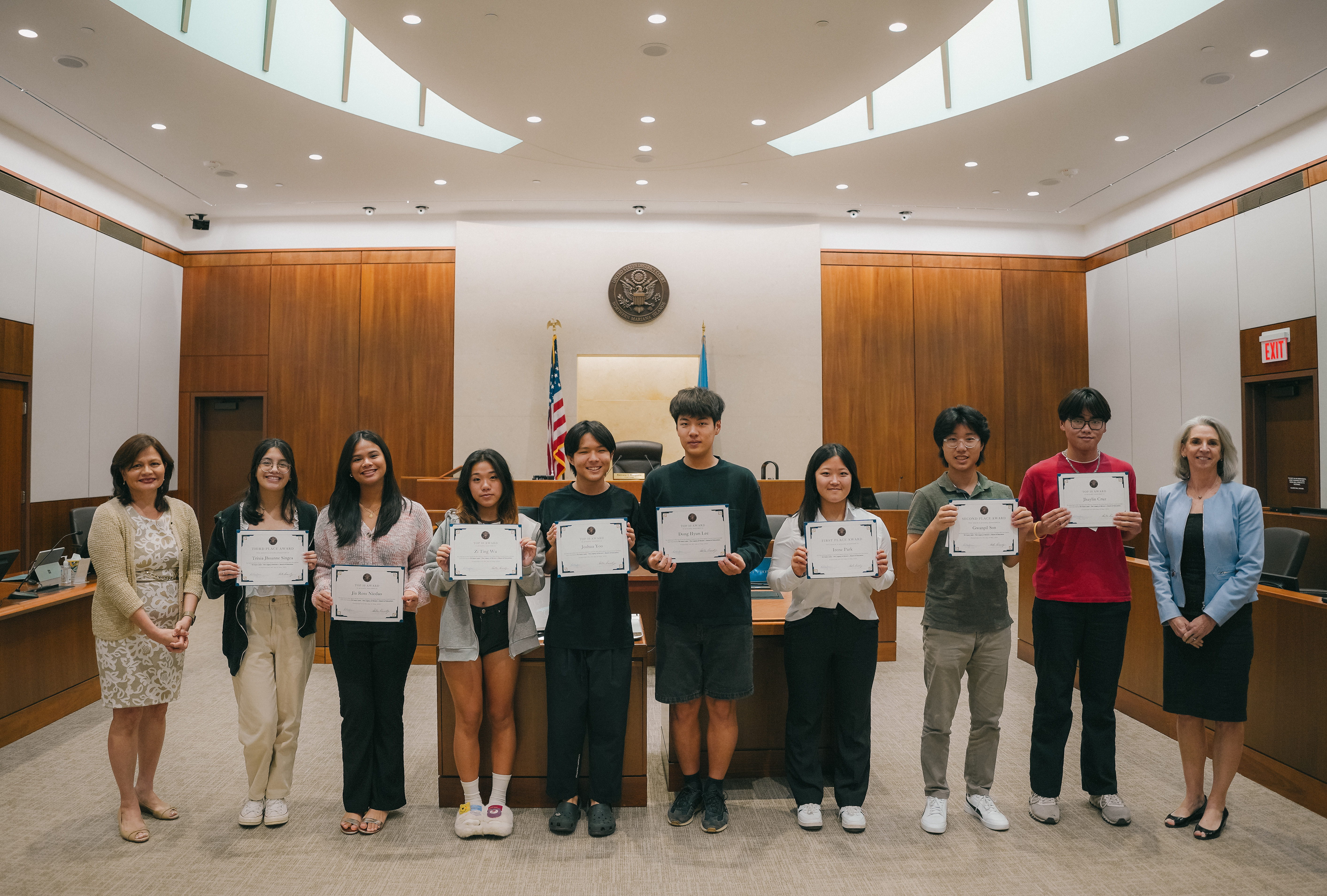 From left, Chief Judge Ramona V. Manglona, 3rd place essay winner Trixia Jhoanne Singca from Marianas High School, Top 10 awardees Jia Ross Nicdao from Marianas High School, Zi Ting Wu, Joshua Yoo, Dong Hyun Lee from Saipan International School, 1st place essay winner Irene Park from Saipan International School, 2nd place essay winner Gwanpil Son from Marianas High School, Top 10 awardee Jhaylin Cruz from Marianas High School, and Magistrate Judge Heather L. Kennedy. (Not in photo: Top 10 awardees Shuang Zhao from Marianas High School and Moshe Sikkel from Saipan International School.)