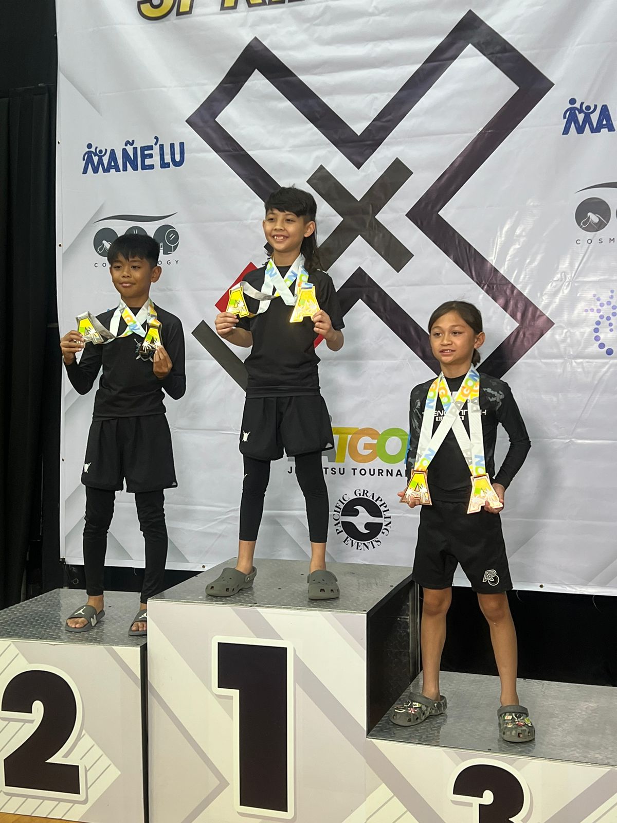 Reiden Travilla, right, poses with his bronze medals during the awards ceremony of the 2024 Patgon Jiu Jitsu Tournament at the UOG Calvo Field House in Mangilao, Guam on Saturday, April 27.
