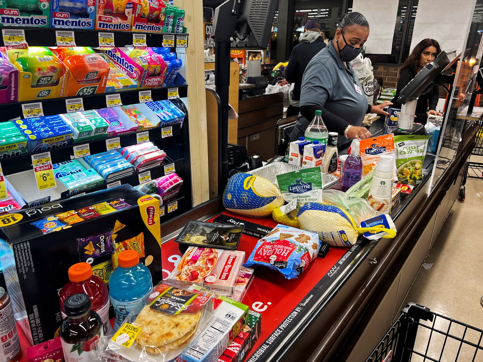 A cashier charges products at a supermarket ahead of the Thanksgiving holiday in Chicago, Illinois, Nov. 22, 2022.