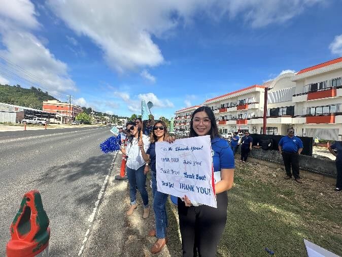 Employees display their signs.