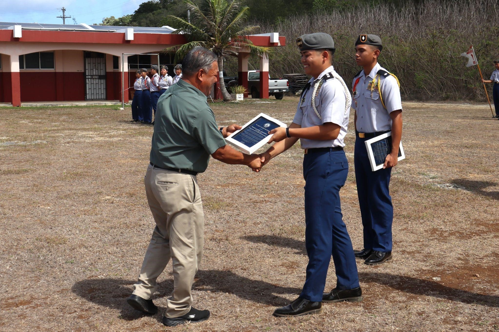 C/CPT Edgard Acollador receives a plaque of recognition from Tinian Mayor Edwin Aldan.