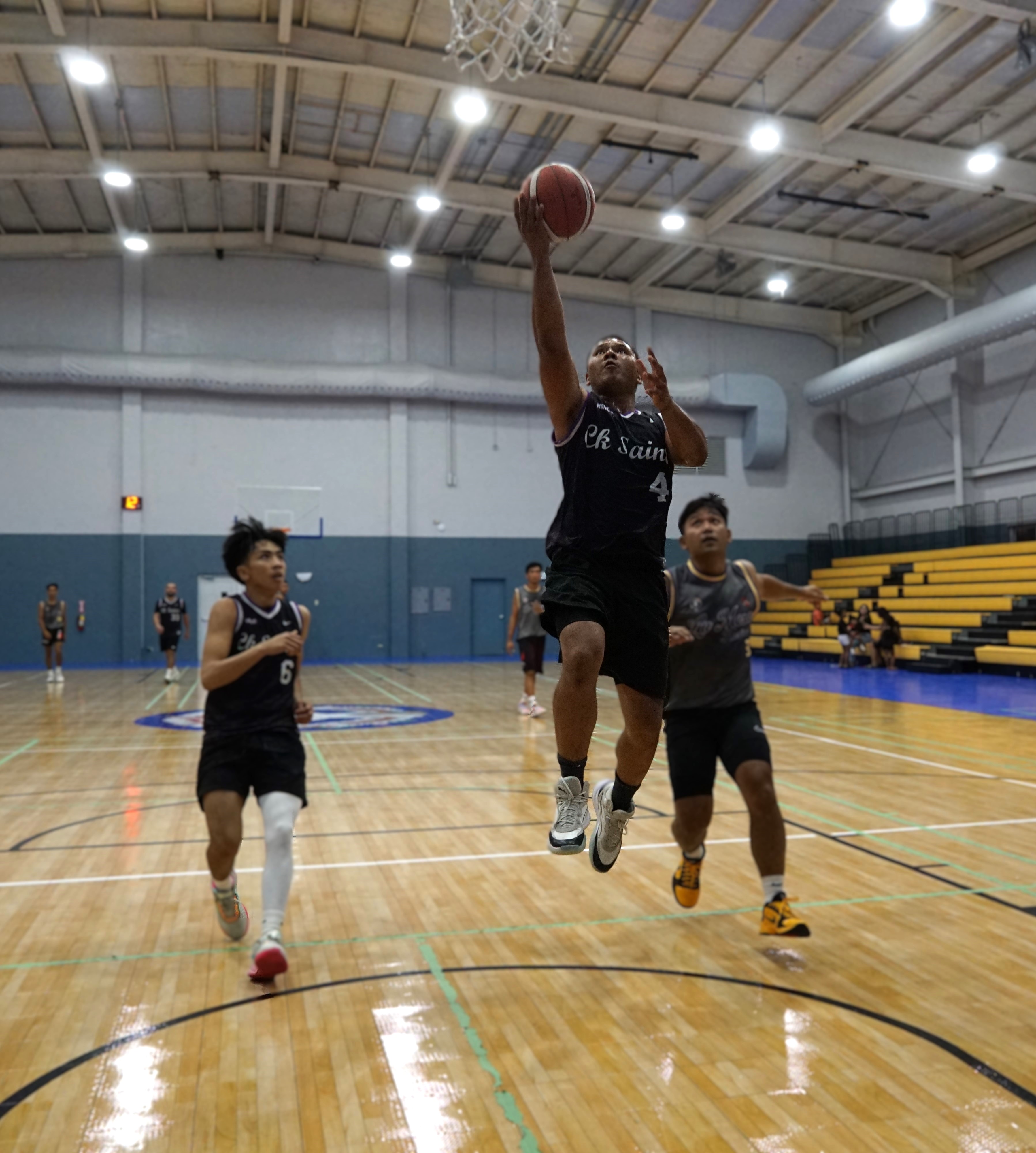 The Saints’ Melvin Manibusan extends for the fastbreak finish during a game against La Mesa Kusina in the Michelob Ultra Cup at the Ada gym on Monday. 
