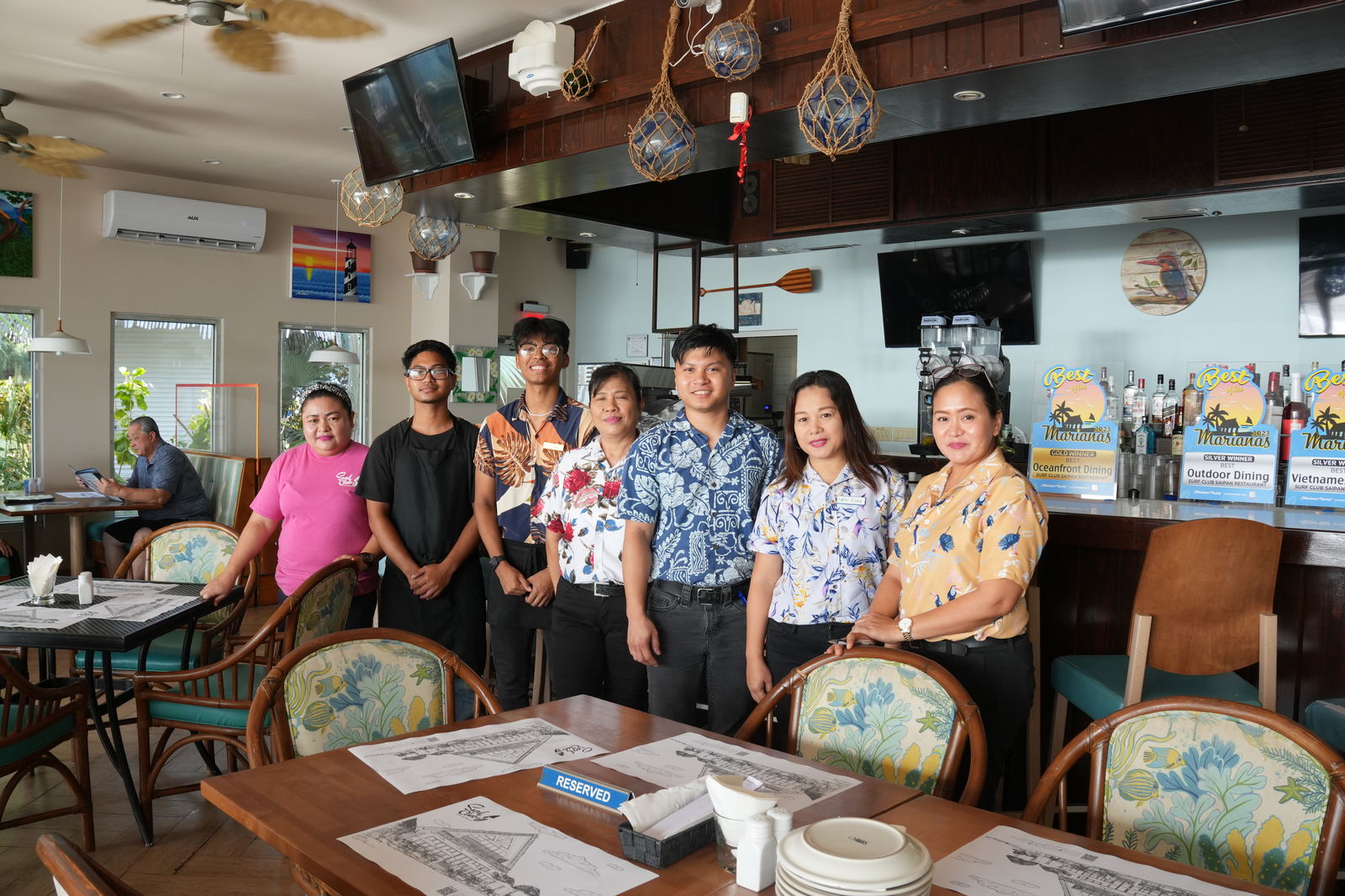Manager Paul Manikad, in blue shirt, with his team at Surf Club