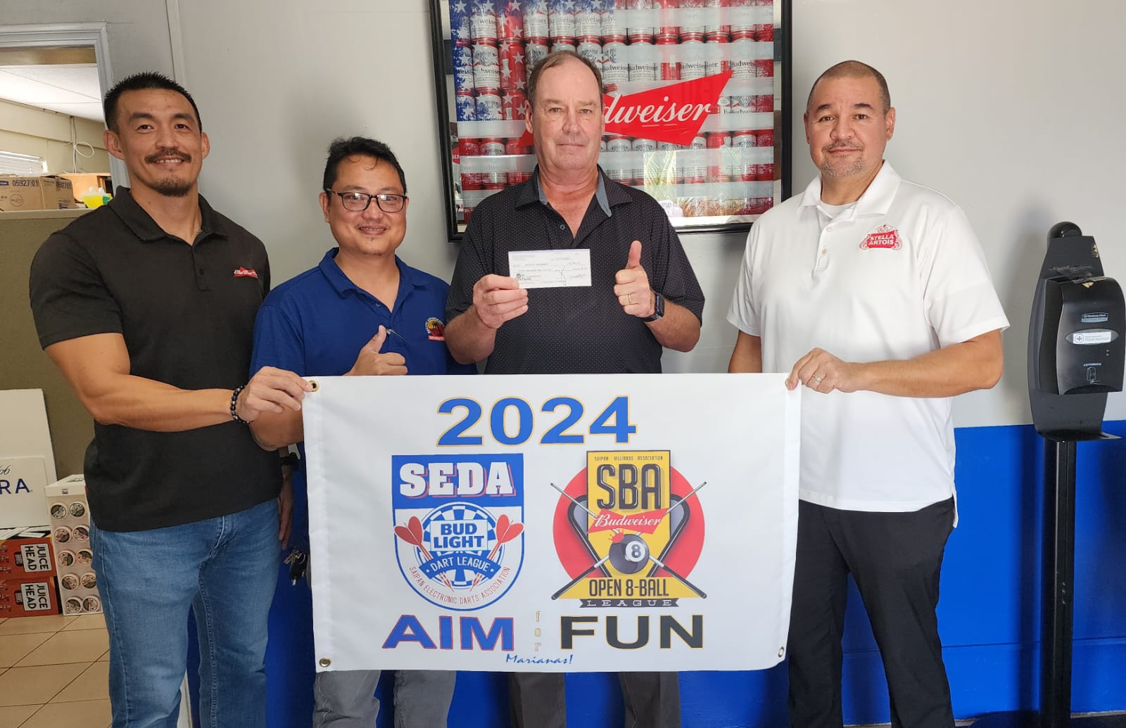 James Lee, Marpac beverage sales manager; Ivan Sales, SEDA & SBA league secretary; Jim Gebhard, general manager, Pacific Amusement Inc.; and Guy Pudney, Marpac resident manager pose for a photo. Marpac is the major sponsor of the SEDA and SBA leagues.