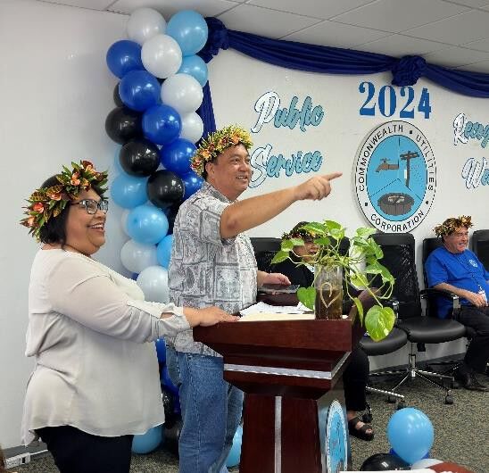Board Treasurer Rufo Mafnas and Board Chair Janice Ada Tenorio address the  employees during the ceremony.