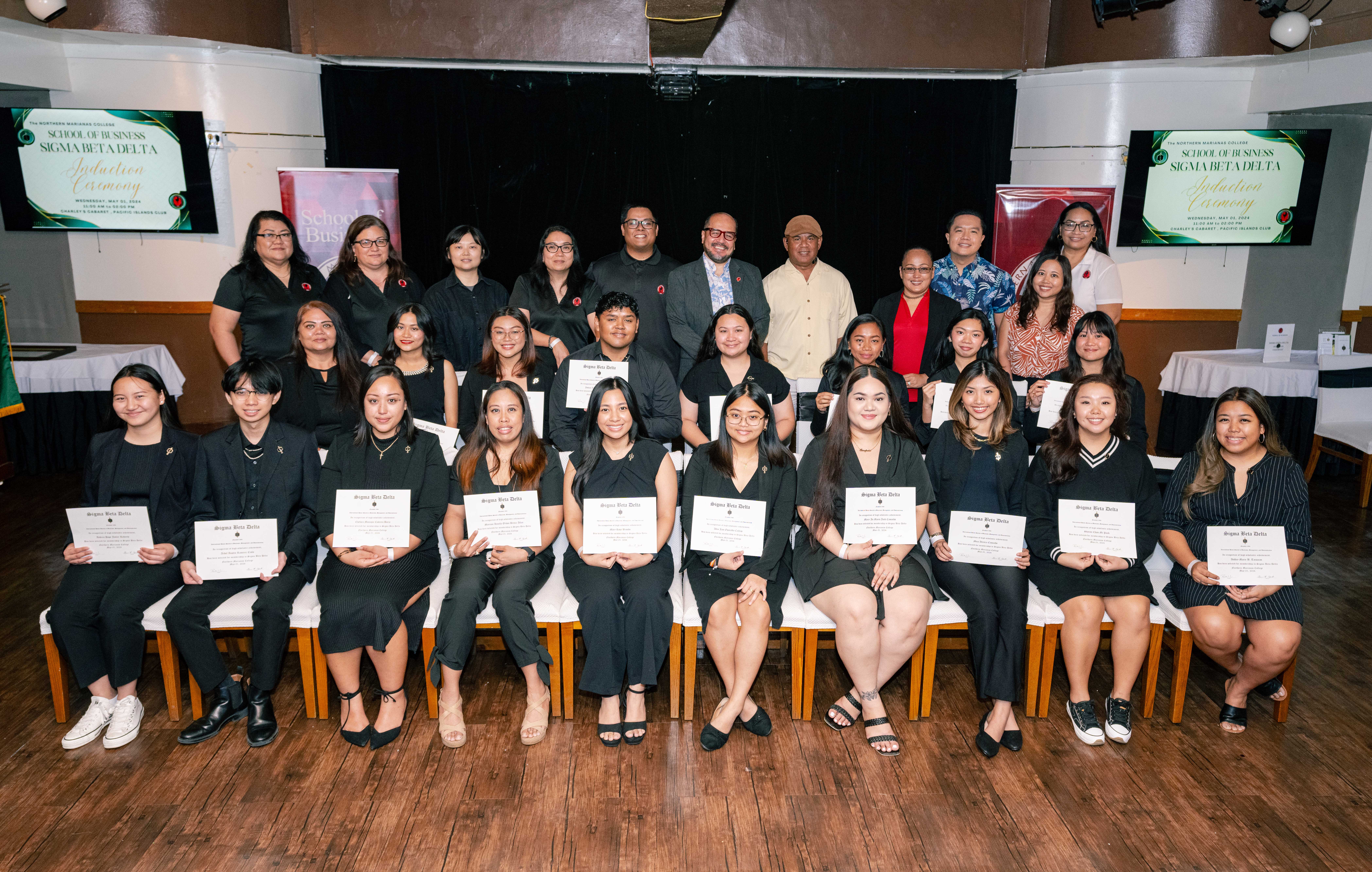 The newest members of Northern Marianas College's Sigma Beta Delta chapter pose for a photo with NMC officials.