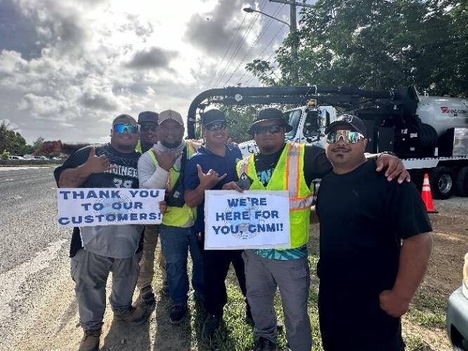 Water and Wastewater employees smile for the camera.