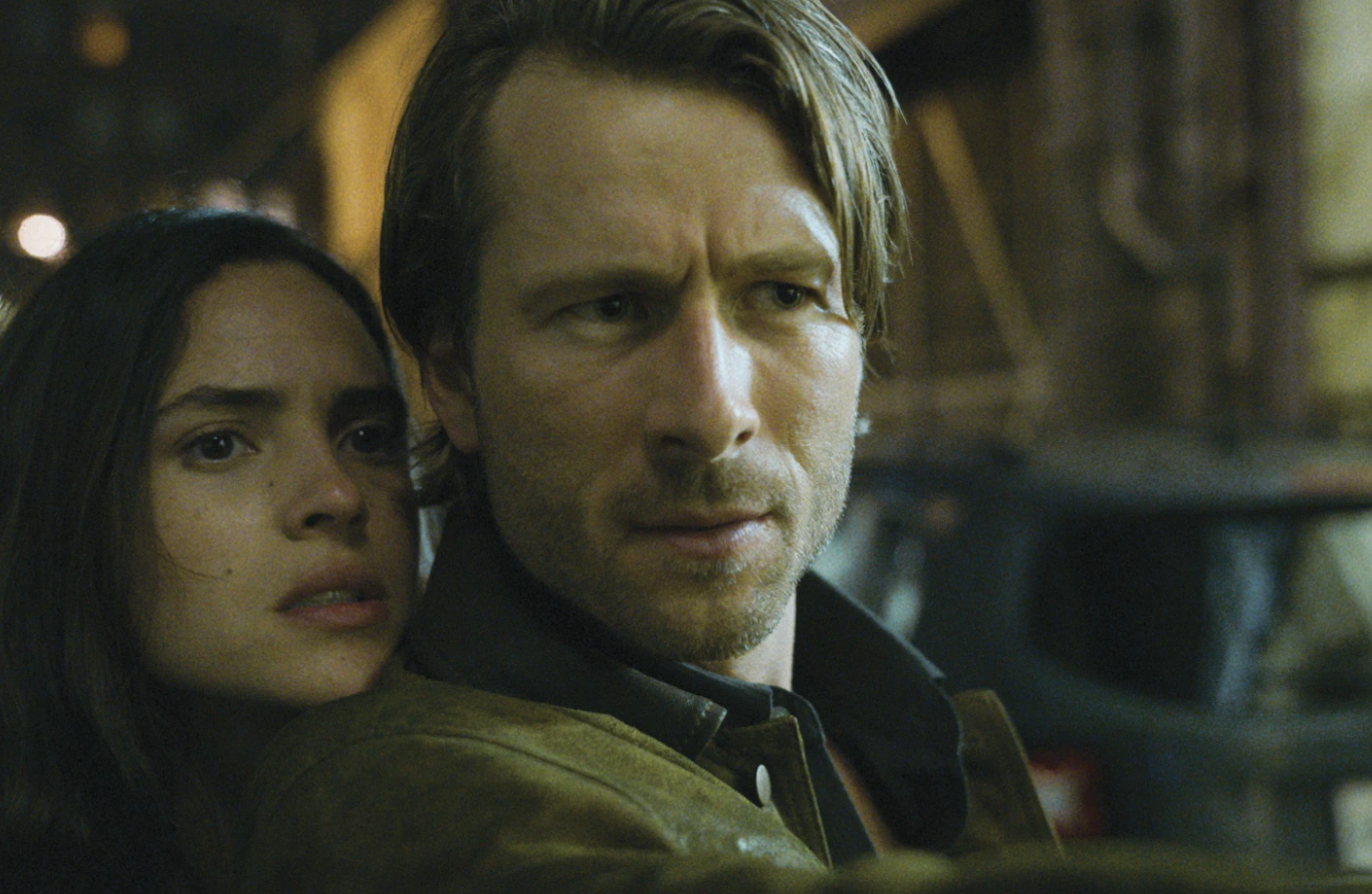 Adria Arjona, left, and Glen Powell in a scene from “Hit Man.”