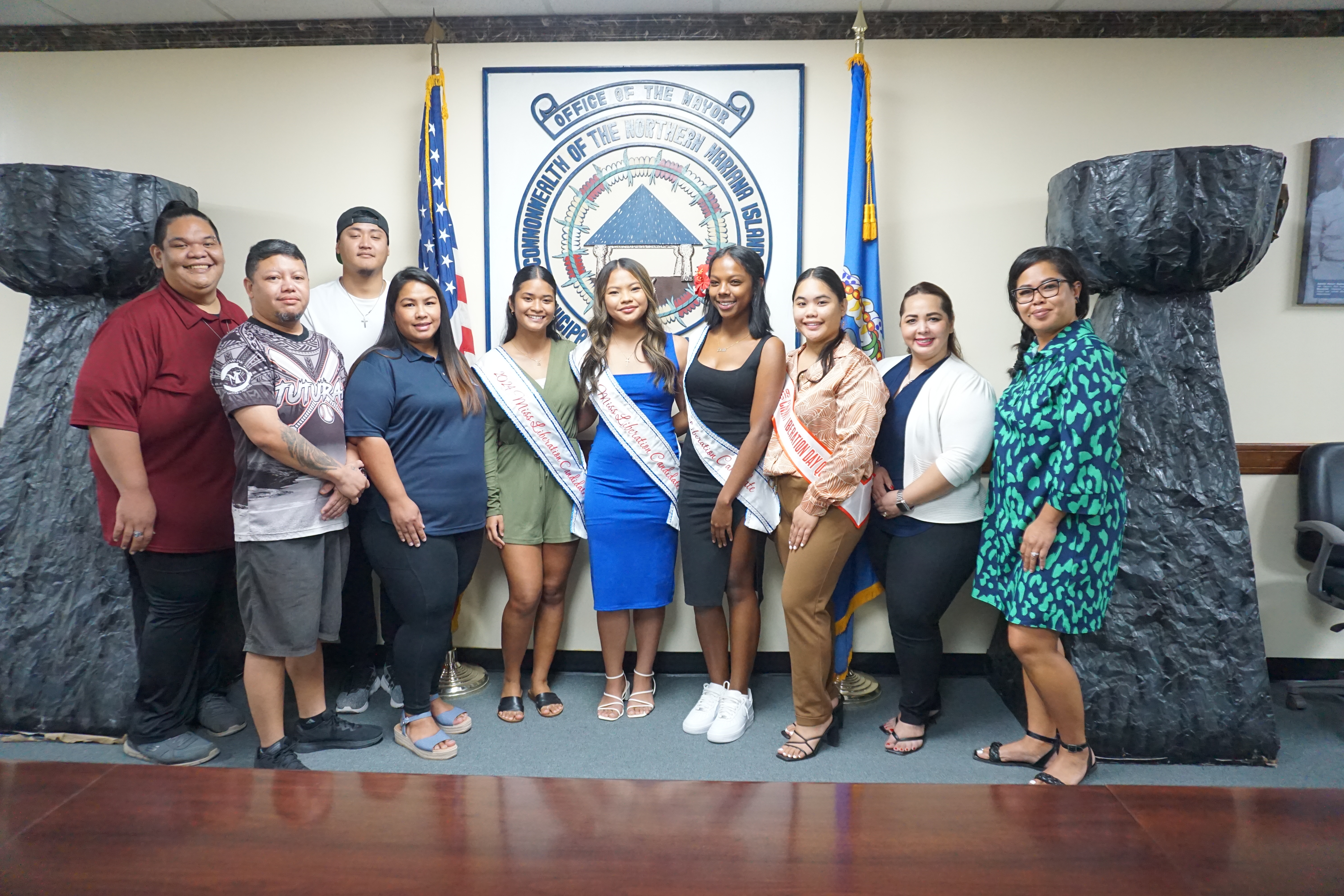 2024 Miss Liberation Queen candidates Nakisha Celis, Xeayda Manglona and Chariane Cabrera Dabney pose for a photo with the Liberation Day Committee members at the Saipan mayor’s office on Friday, May 17.