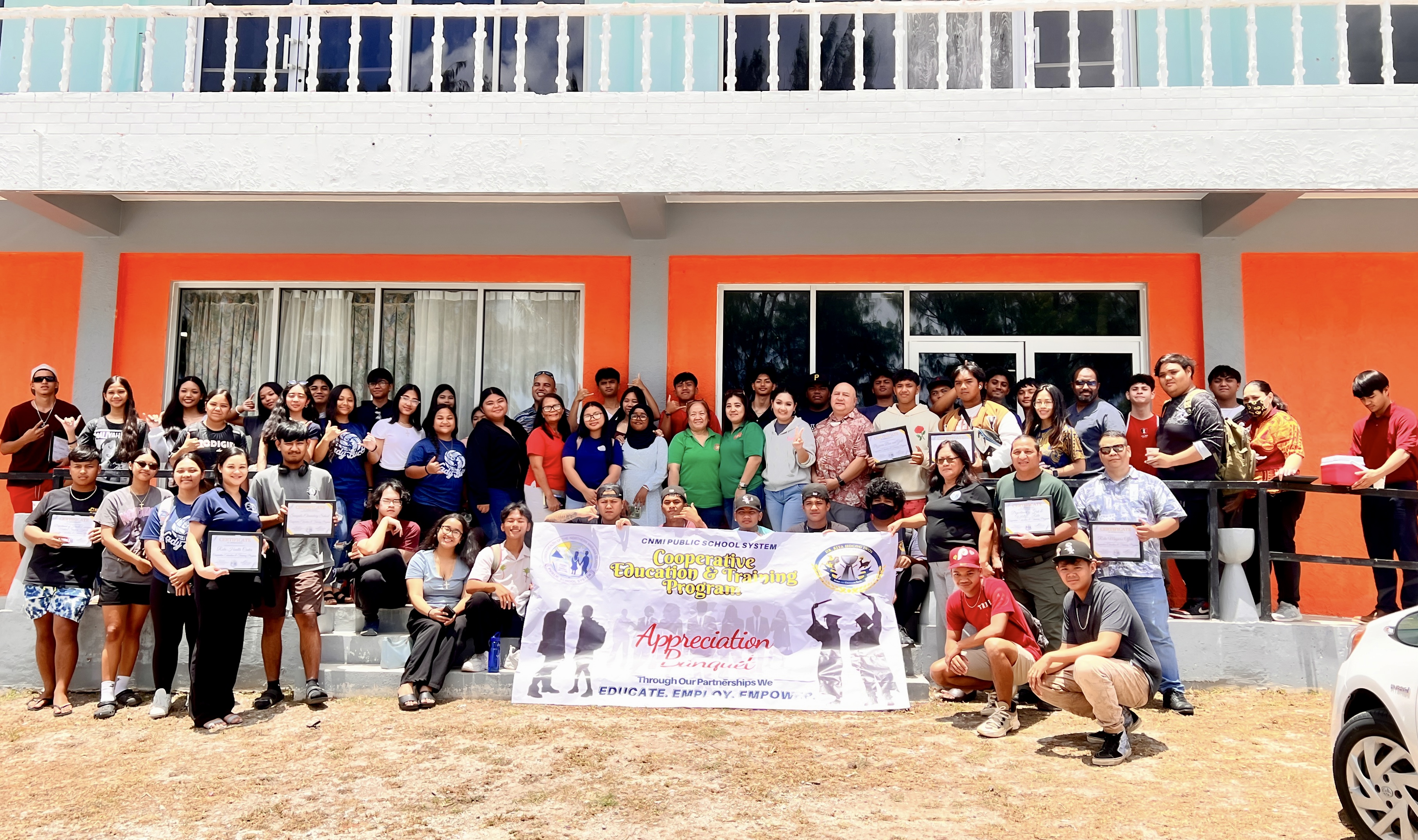 Owners and representatives of Rota government agencies and private businesses pose for a photo with their more than 60 high school interns. Joining them are Commissioner of Education Dr. Lawrence F. Camacho, Public School System-Co-Op Program Coordinator Brandon Nicholas and Dr. Rita Hocog Inos Junior-Senior High School Principal Annette Calvo.