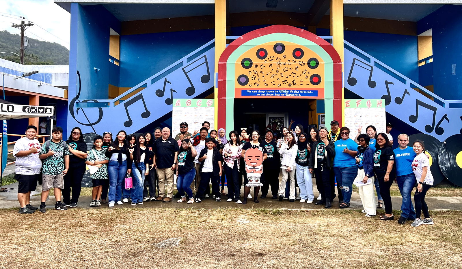 Members of the Youth Advisory Panel of Dr. Rita Hocog Inos Junior-Senior High School and the various presenters of the Youth Summit pose for a photo with Commissioner of Education Dr. Lawrence F. Camacho at the conclusion of the day-long event on May 17.
