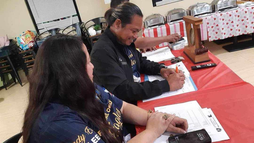 Saipan Magalahi Eagles Club President Eagle Moises Tagle Jr. signs the scholarship program agreement.