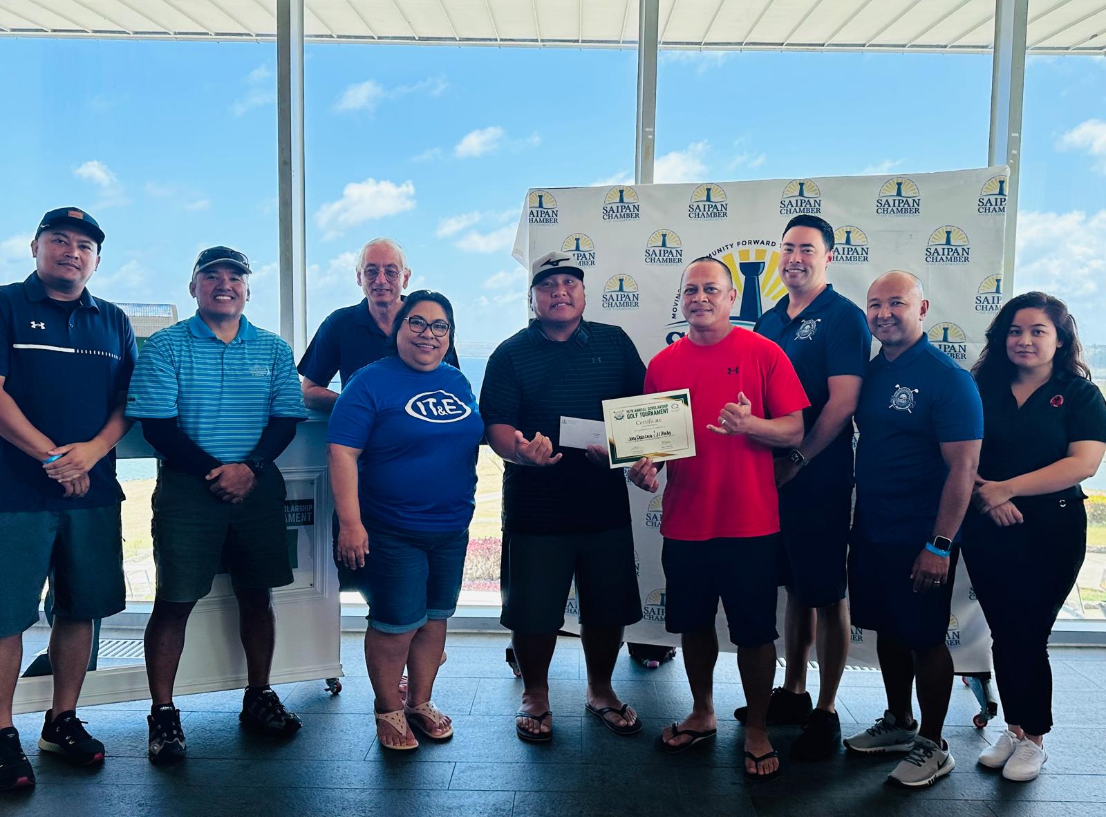 Joey Dela Cruz and JJ Atalig pose for a photo with Saipan Chamber of Commerce officials during the awards ceremony of the 15th Annual SCC Scholarship Golf Tournament at the Laolao Bay Golf & Resort on Saturday. 