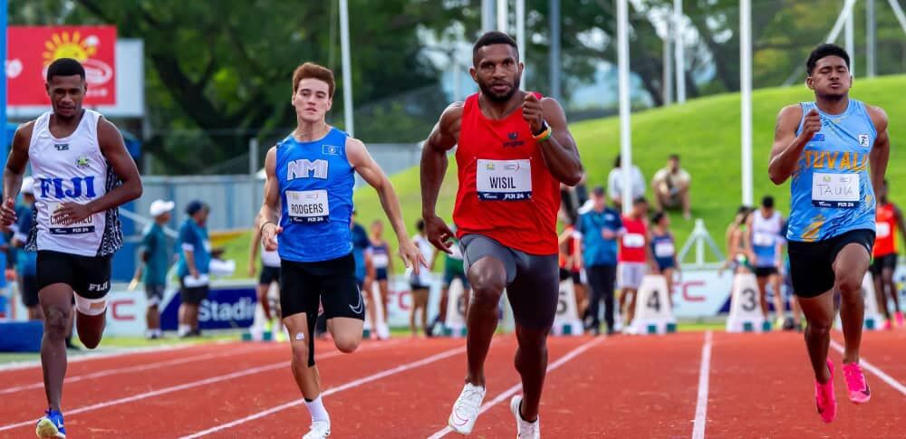 Theodore Rodgers pushes forward with the rest of the runners in the Senior Men 100m Heats of the Oceania Athletics Championships 2024 in Suva, Fiji.